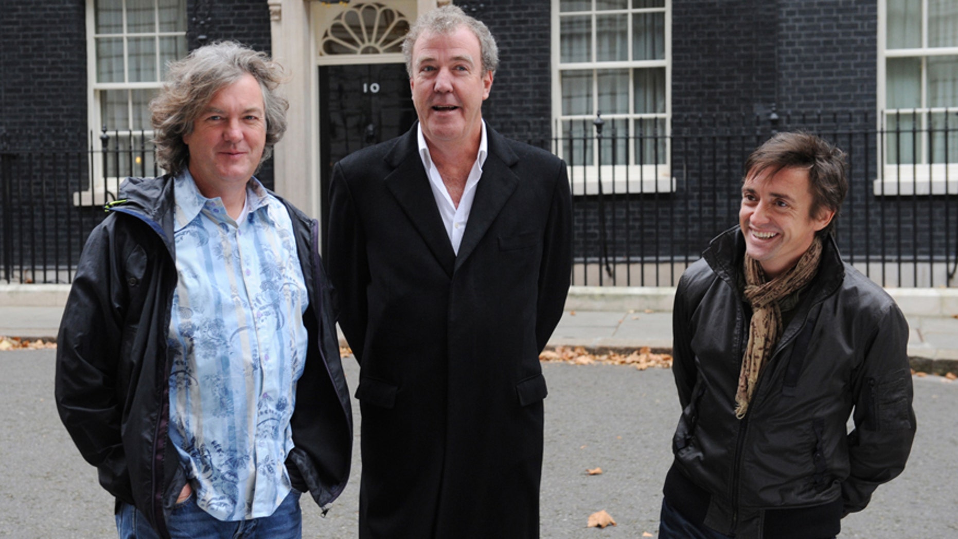 FILE - A Nov. 29, 2011 photo from files showing television show Top Gear presenters James May, left, Jeremy Clarkson, centre, and Richard Hammond standing outside No.10 Downing Street in London. The BBC said Tuesday it has suspended "Top Gear" host Jeremy Clarkson following a "fracas" with a producer. The popular TV presenter was suspended pending an investigation, the broadcaster said, without providing details. Clarkson, who has been in trouble before for behavior and remarks deemed offensive and provocative, was given a so-called final warning last year following a racism row. (AP Photo/PA, Stefan Rousseau) UNITED KINGDOM OUT NO SALES NO ARCHIVE