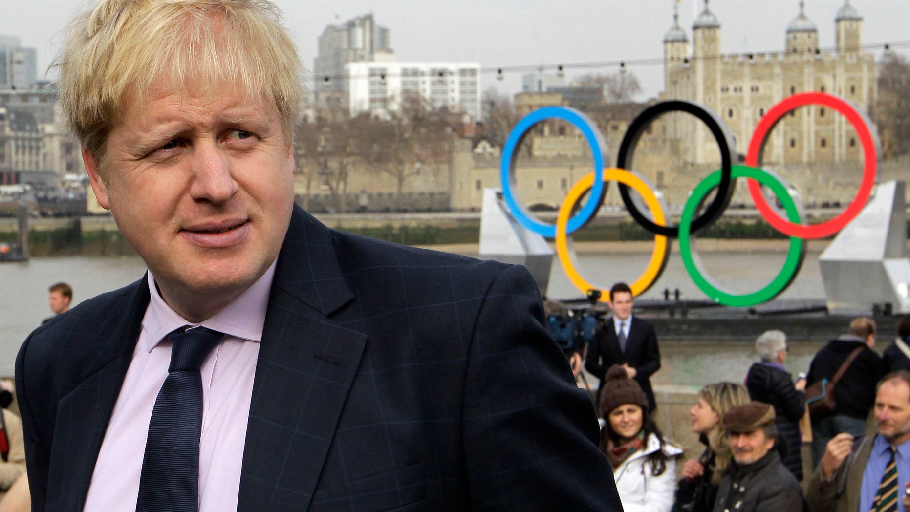 Feb. 28, 2012: This file photo shows mayor of London Boris Johnson as he waits for a giant Olympic Rings to start its journey down the River Thames in London to mark 150-days until the start of the London 2012 Olympic games.