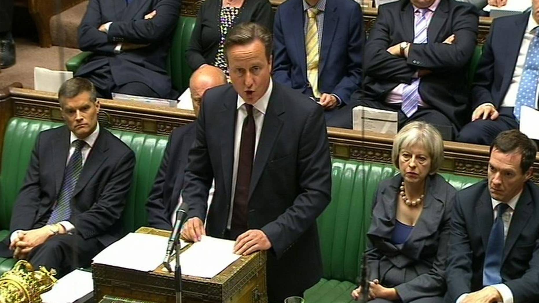 In this image taken from TV, Britain's Prime Minister David Cameron makes a statement at the House of Commons, London, Monday Sept. 7, 2015. David Cameron says the U.K. will re-settle up to 20,000 Syrian refugees from camps in Turkey, Jordan and Syria over the next five years. (PA via AP) UNITED KINGDOM OUT NO SALES NO ARCHIVE