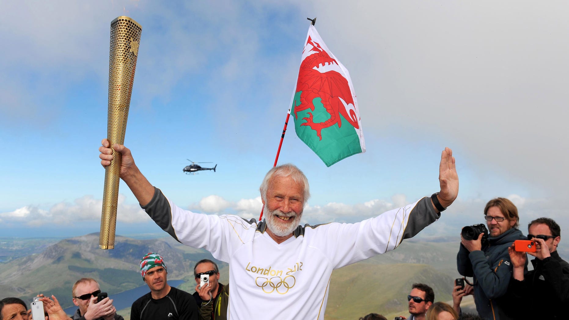 May 29, 2012: In this file photo made available by LOCOG, Sir Chris Bonington holds the Olympic Flame on the top of Mount Snowdon in Wales during the Olympic Torch Relay.