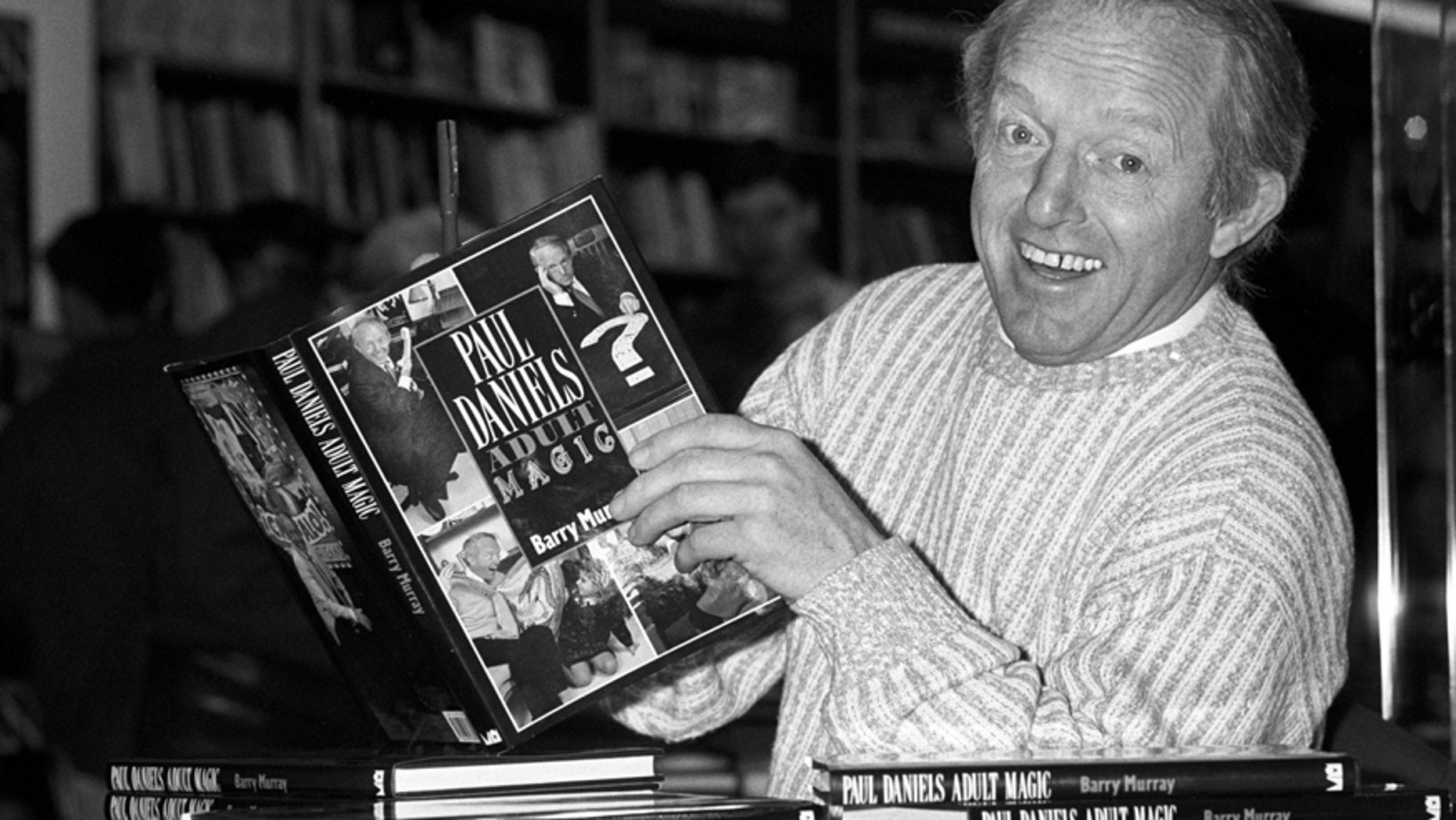 This is a Dec. 2, 1989 file photo of British magician Paul Daniels as he holds with a copy of his book 'Adult Magic' at Whiteleys book shop in London.
