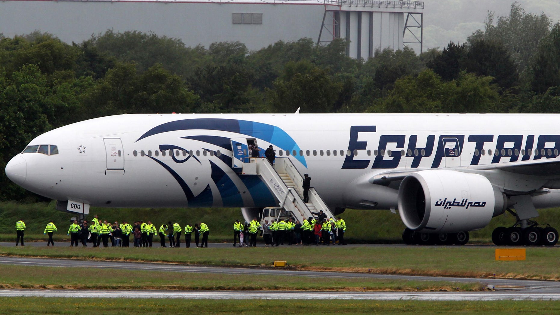 June 15, 2013: Passengers leave the Egyptair aircraft at Prestwick Airport, Scotland, after it was diverted while en route from Cairo to New York. It is reported that BBC employee Nada Tafik, who was on board the plane, said she found a note in a toilet apparently threatening to start a fire.
