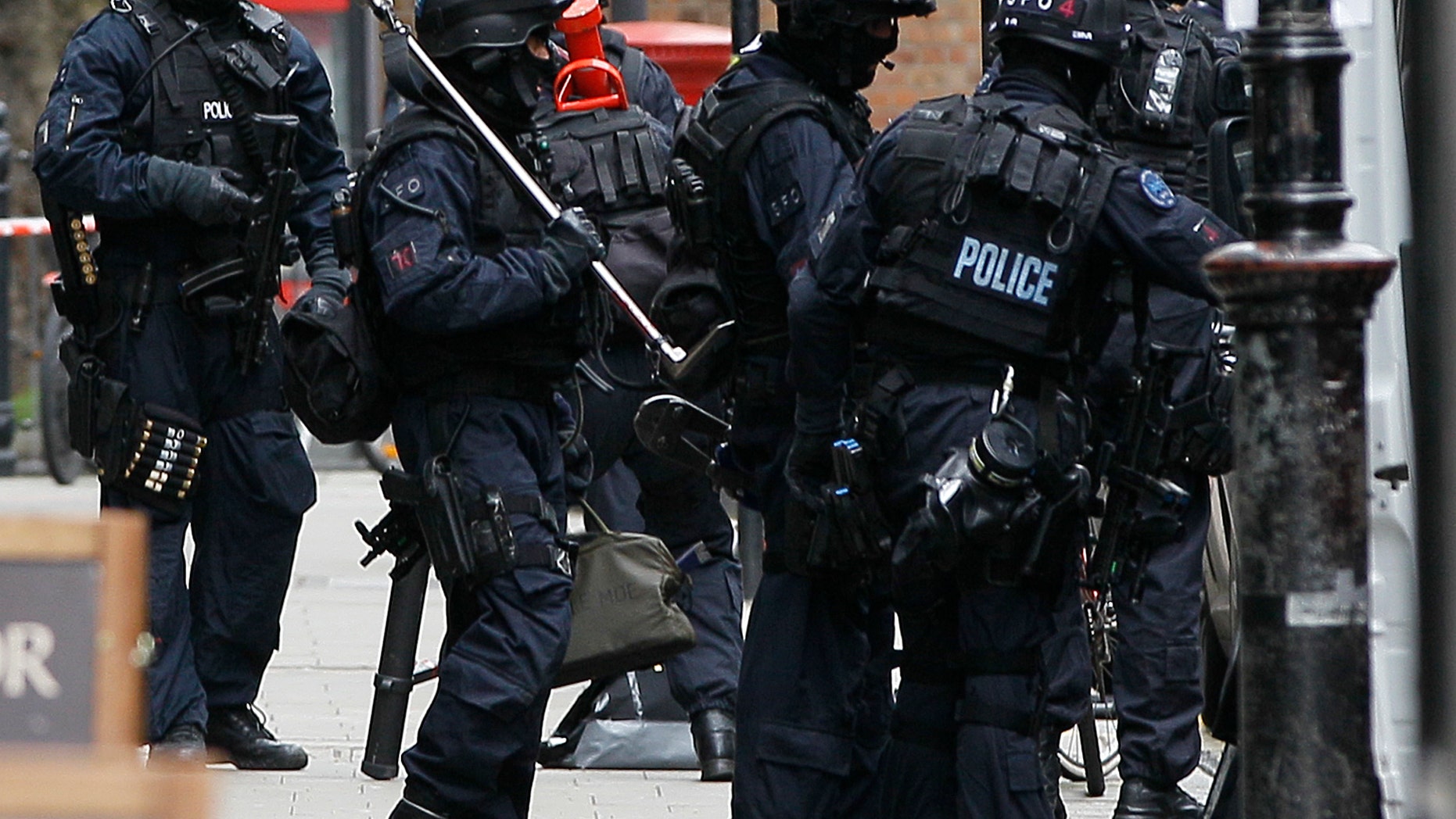 April 27, 2012: Armed police carry equipment outside a building near Tottenham Court Road in central London after an incident was reported in the area.