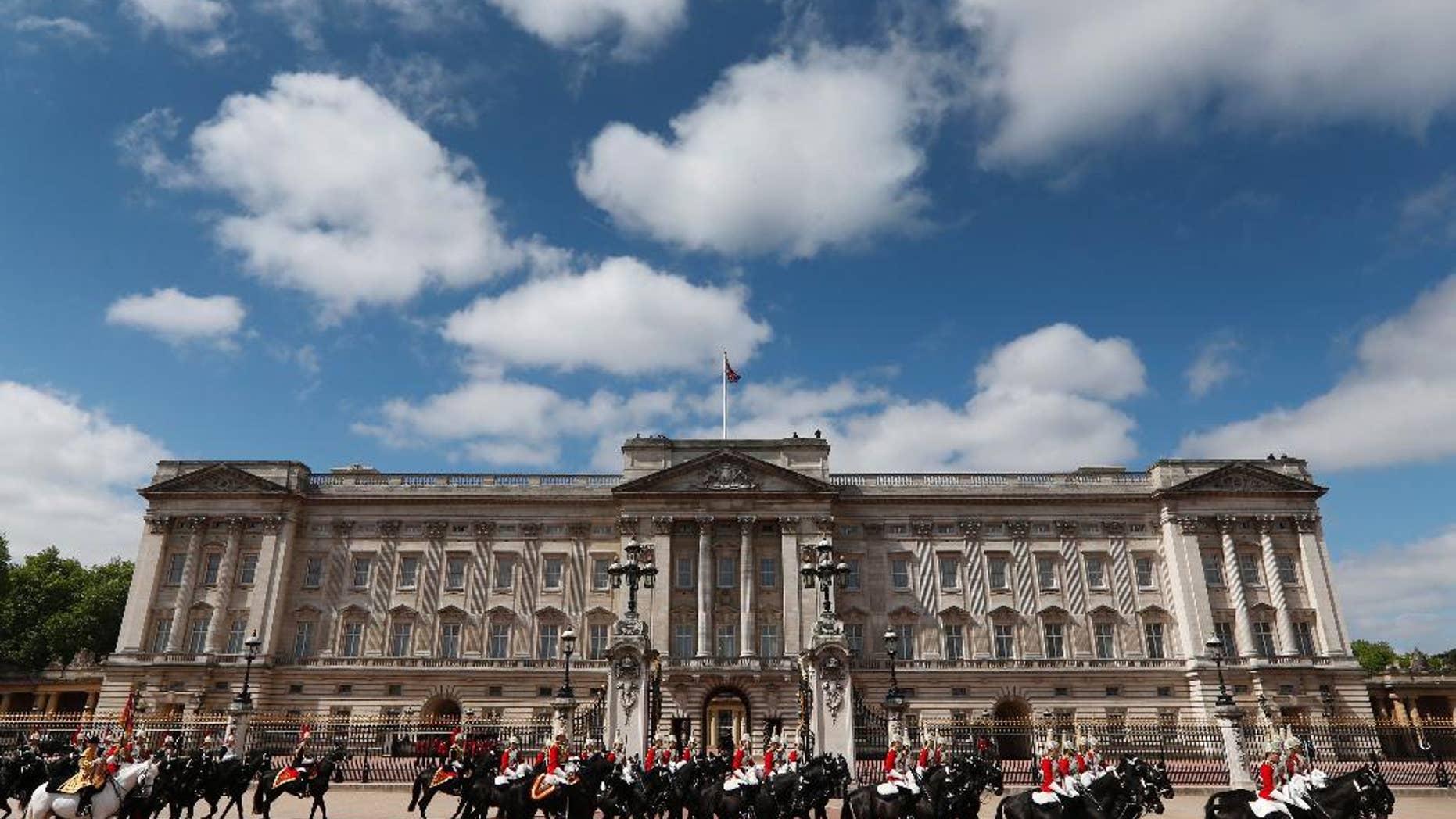 FILE - This is a Saturday, June 8, 2013 file photo members of Household Cavalry as they ride outside Buckingham Palace in central London. A mushroom with hallucinogenic properties has been found growing at Buckingham Palace but no one suspects Queen Elizabeth II of cultivating the magic mushroom. The Amanita muscaria was found growing wild in the extensive palace gardens during preparations for a television show. Palace officials said Friday Dec. 12, 2014 there are several hundred species of mushrooms growing in the palace gardens, including a number of naturally occurring Amanita muscaria. (AP Photo/Lefteris Pitarakis)