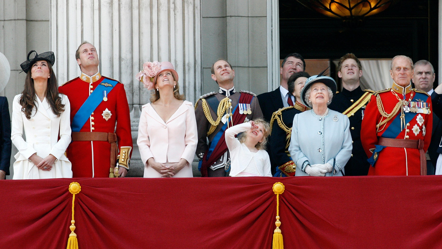 June 11, 2011: Britain's Duchess of Cambridge, Prince William the Duke of Cambridge, Countess of Wessex Sophie, Prince Edward the Earl of Wessex, their daughter Louise, Princess Anne, partially seen, her husband Tim Lawrence, Britain's Queen Elizabeth II, Prince Harry, Prince Philip the Duke of Edinburgh, and Prince Andrew, watch a Royal Air Force flypast on the balcony of Buckingham Palace.