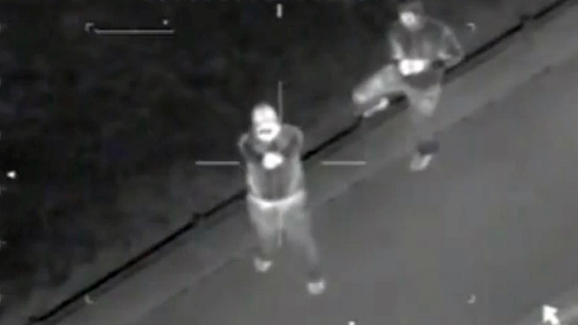 This infra-red video still image taken from a police helicopter issued by West Midlands Police on Saturday Aug. 20 2011 shows what the police say are hooded youths firing shots at the helicopter during the riots in Birmingham, central England on August 9. The force said 11 shots were fired. Chief Constable Chris Sims called it "a concerted and organized attempt to kill or injure police officers."