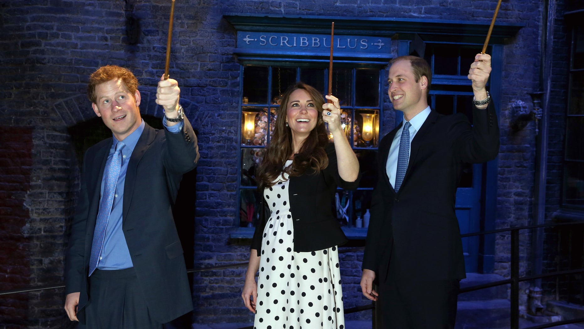 April 26, 2013 - Britain's Kate the Duchess of Cambridge, husband Prince William, and his brother Prince Harry raise wands on the film set of Diagon Alley in the Harry Potter Films at Warner Bros. Studios, Leavesden; near Watford, England.