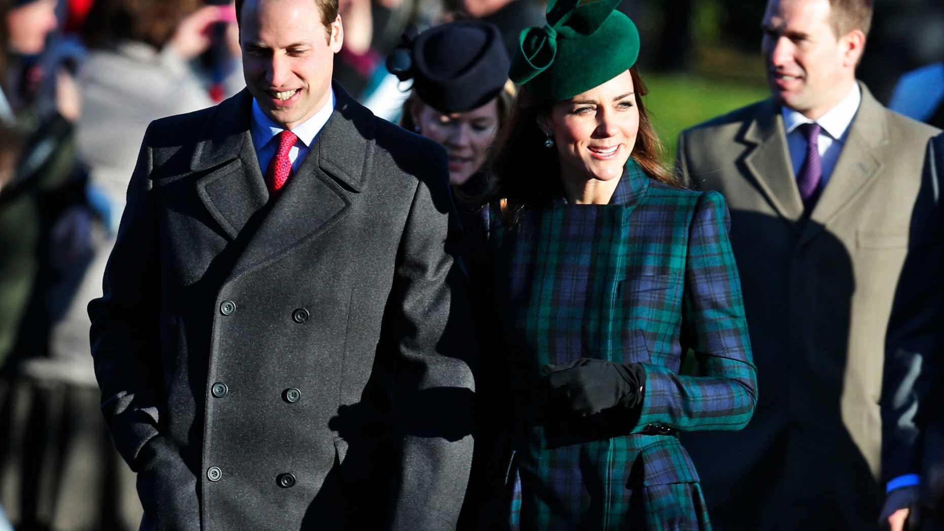 Britain's Prince William, left, accompanied by his wife Kate, Duchess of Cambridge, arrive to attend a Christmas Day Service with other members of the royal family at St. Mary's church on the grounds of Sandringham Estate, the Queen's retreat, in Norfolk, England, Wednesday, Dec. 25, 2013. (AP Photo/Lefteris Pitarakis)