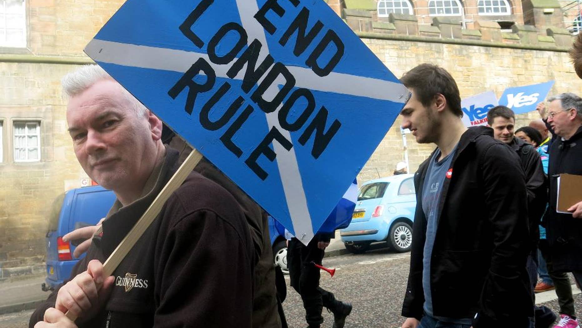 FILE - In this March 15, 2014 file photo, a demonstrator carries a sign during a pro-independence march in Edinburgh, Scotland. A Sept. 18, 2014 referendum will determine if Scotland becomes independent of the United Kingdom. (AP Photo/Jill Lawless)