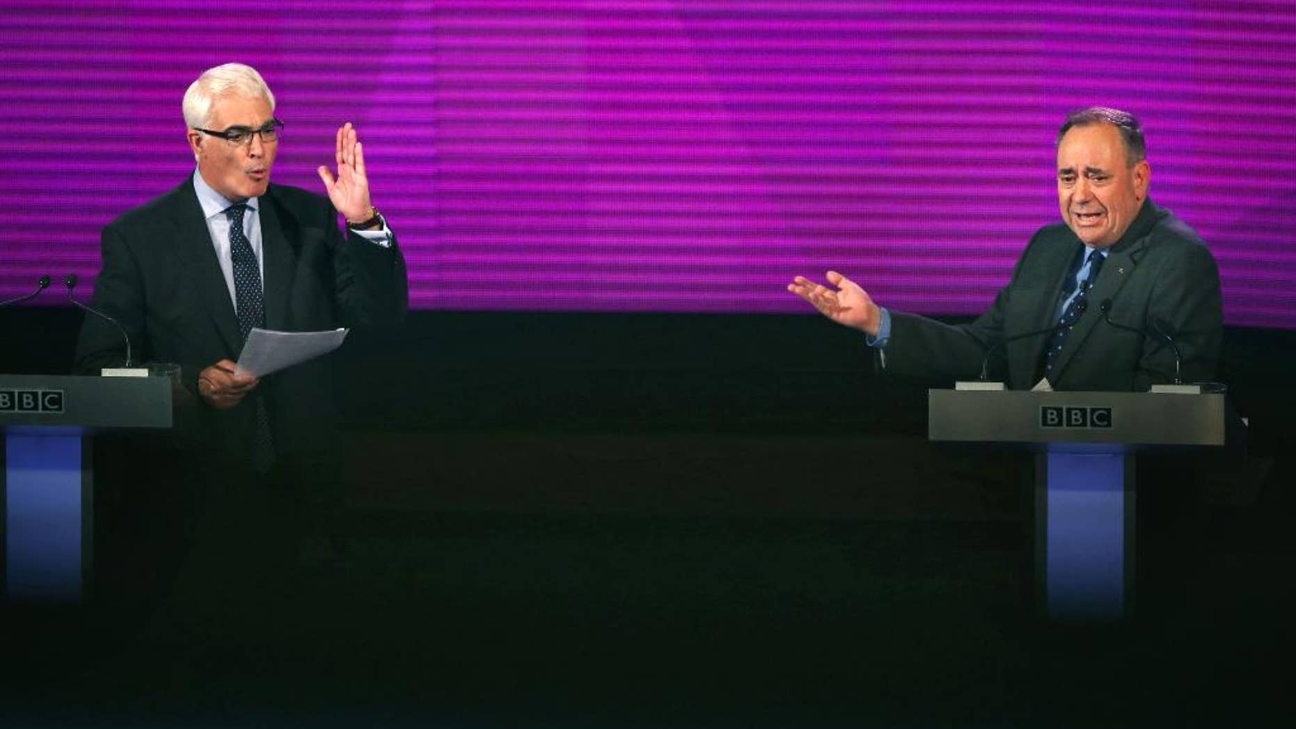 Better Together leader Alistair Darling, left, and Scotland's First Minister, Alex Salmond, both gesture whilst they take part in the second television debate over Scottish independence at Kelvingrove Art Gallery and Museum in Glasgow, Scotland, Monday Aug. 25, 2014. (AP Photo/PA, David Cheskin) UNITED KINGDOM OUT NO SALES NO ARCHIVE