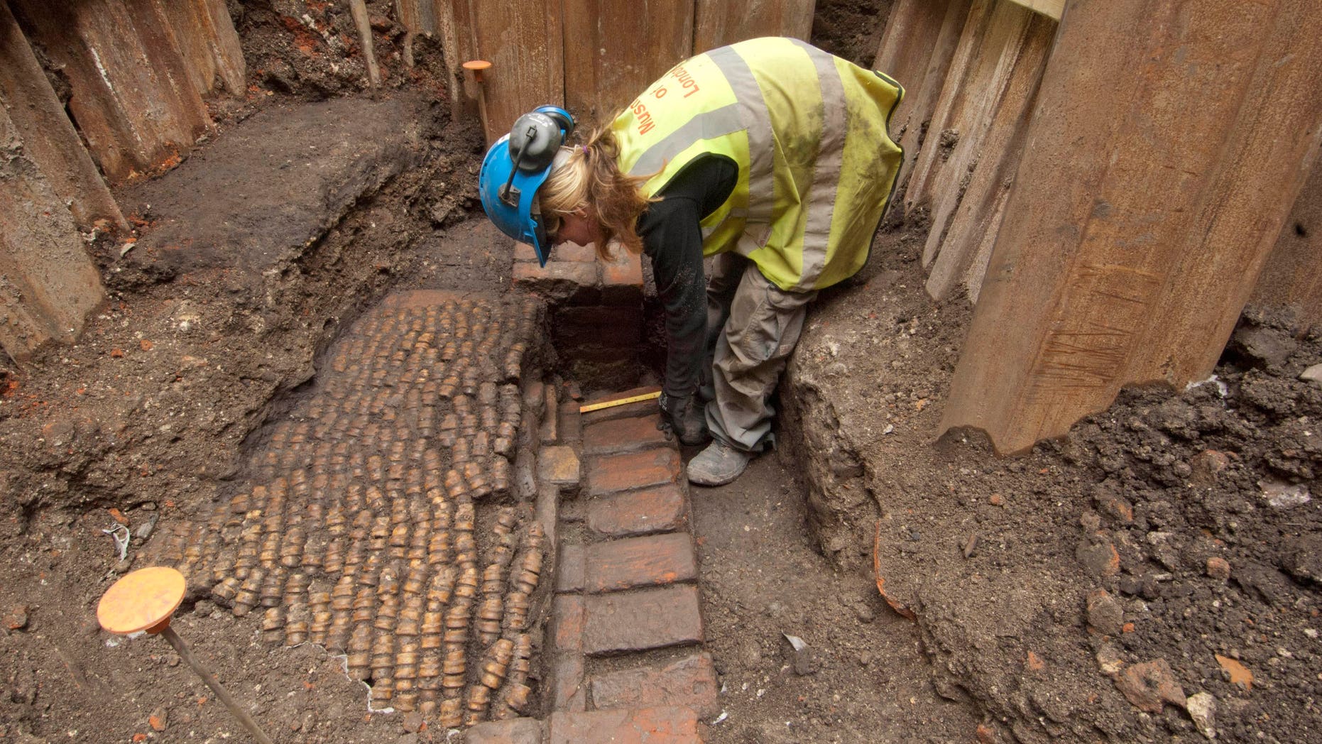 June 6, 2012: An archaeologist undertakes initial excavation work at the site of The Curtain Theatre in London in October 2011.