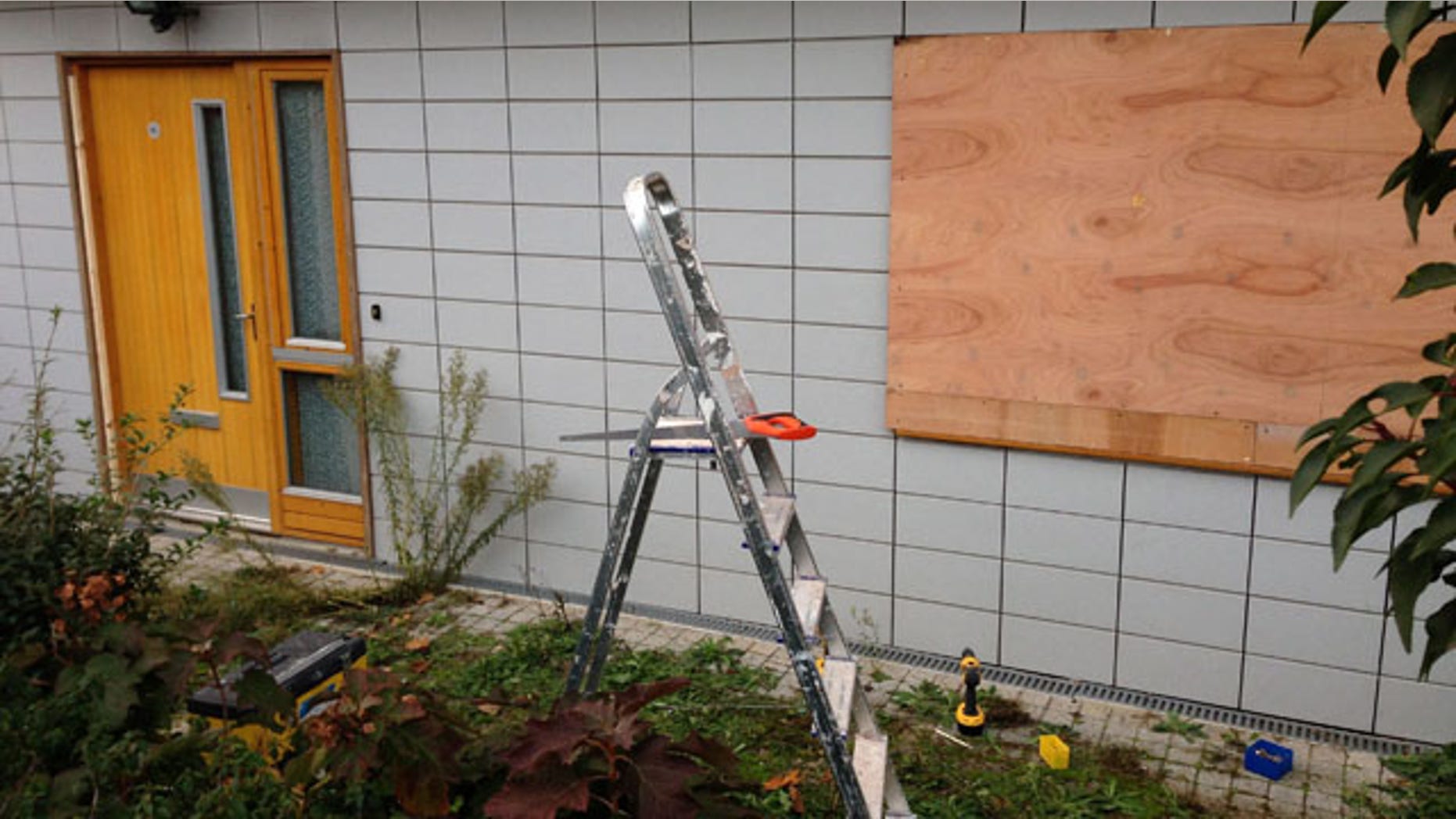 November 25, 2013: The boarded up window of the residence, where two suspects allegedly held three women against their will, in Brixton, London. British police investigating a slavery case involving three female victims say they are investigating 13 London addresses linked to the two suspects. Police said Monday that inquiries into the new addresses followed an extensive search of an apartment in the Brixton neighborhood of south London. (AP Photo/PA, Oliver Duggan)
