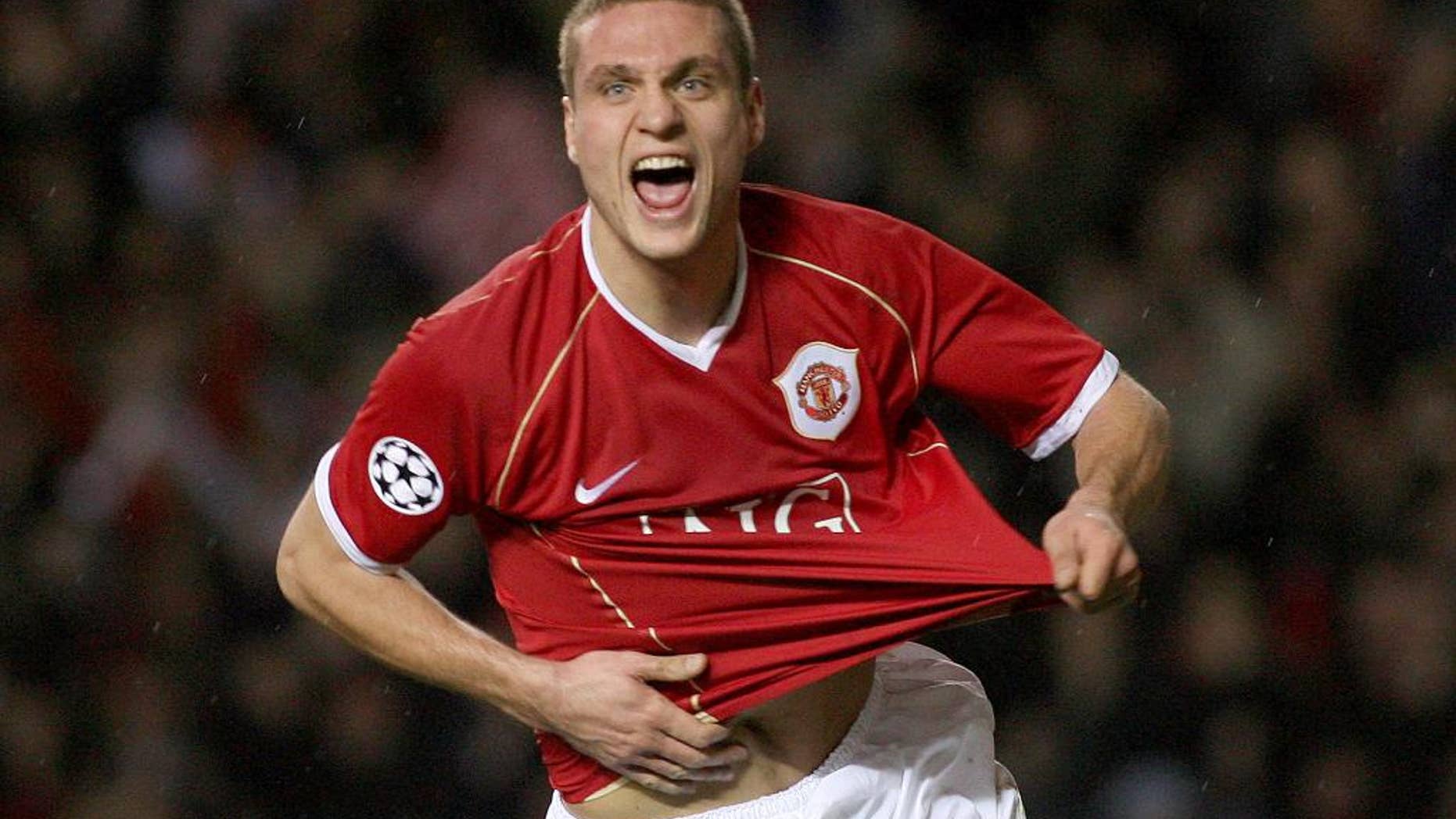 FILE - This is a Wednesday Dec. 6, 2006 file photo of Manchester United's Nemanja Vidic as he celebrates scoring against Benfica during their Group F Champions League soccer match at Old Trafford, Manchester, England. Inter Milan said Wednesday March 5, 2014 Manchester United defender Nemanja Vidic will join the club for the start of next season. (AP Photo/Steven Governo, File)
