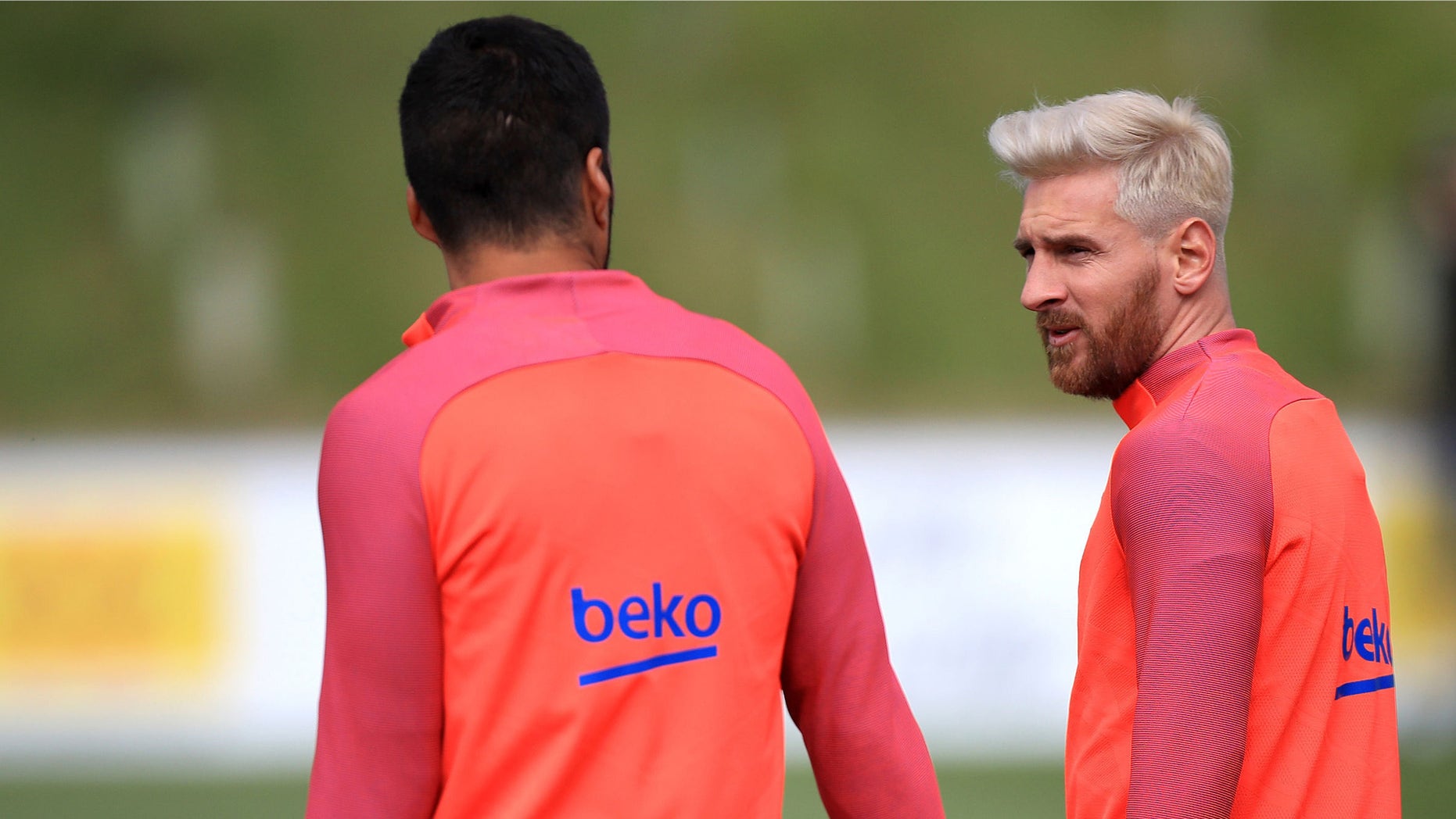 Barcelona's star striker Lionel Messi, right, speaks with a teammate during a training session at St George's Park, Burton, England Tuesday July 26, 2016. Barcelona are using the English FA's St. George's Park as a summer training camp. (Mike Egerton/PA via AP)