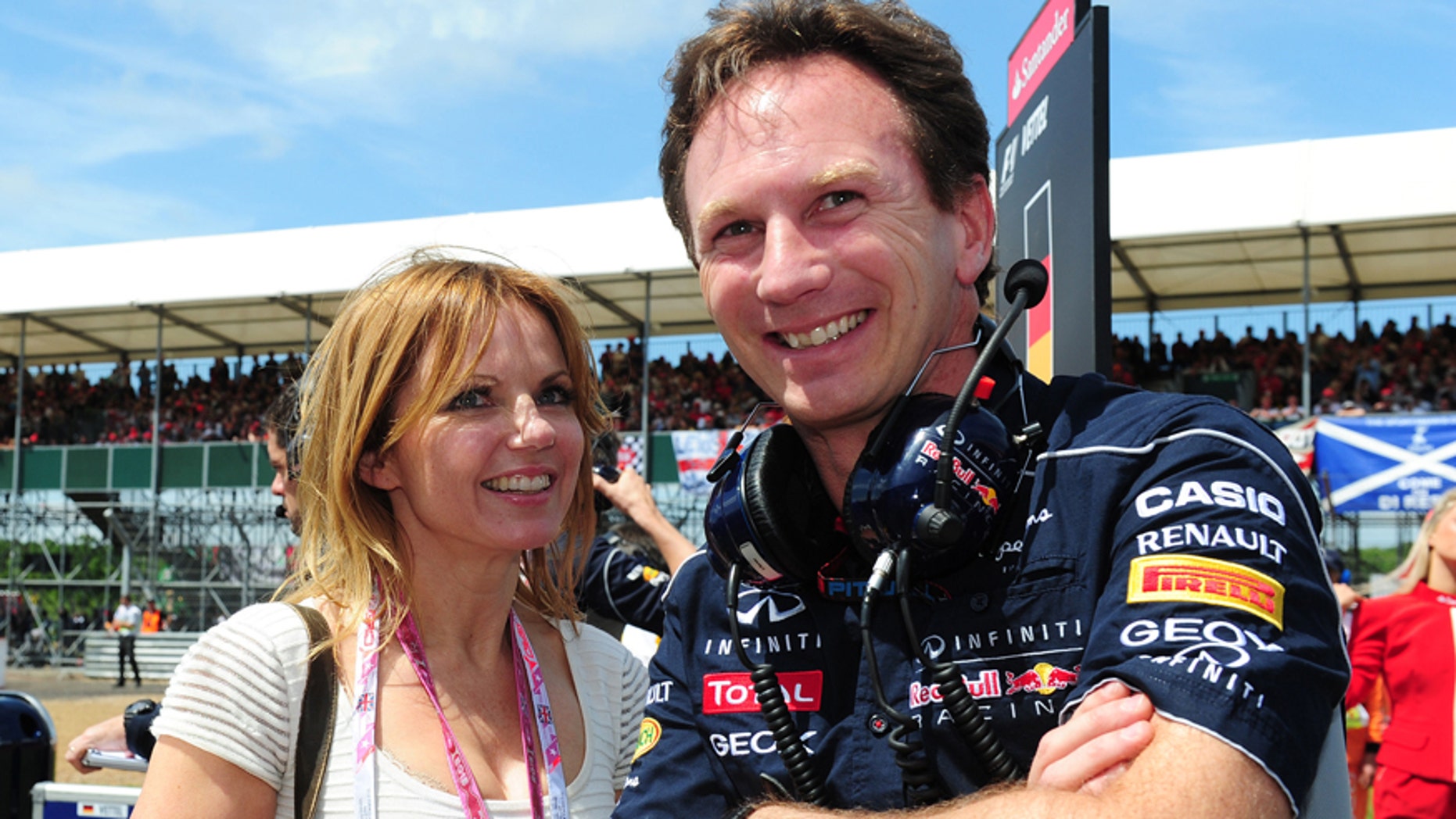 FILE - In this June 30, 2013 file photo Red Bull team principal Christian Horner and Geri Halliwell stand on the grid before the British Grand Prix at Silverstone Circuit, England. Halliwell, 42, says in a notice Tuesday Nov. 11, 2014 in the Times of London that she will wed Red Bull team principal Christian Horner, 40. The announcement did not say when the wedding is to take place. (AP Photo/PA, Anna Gowthorpe, File) UNITED KINGDOM OUT NO SALES NO ARCHIVE