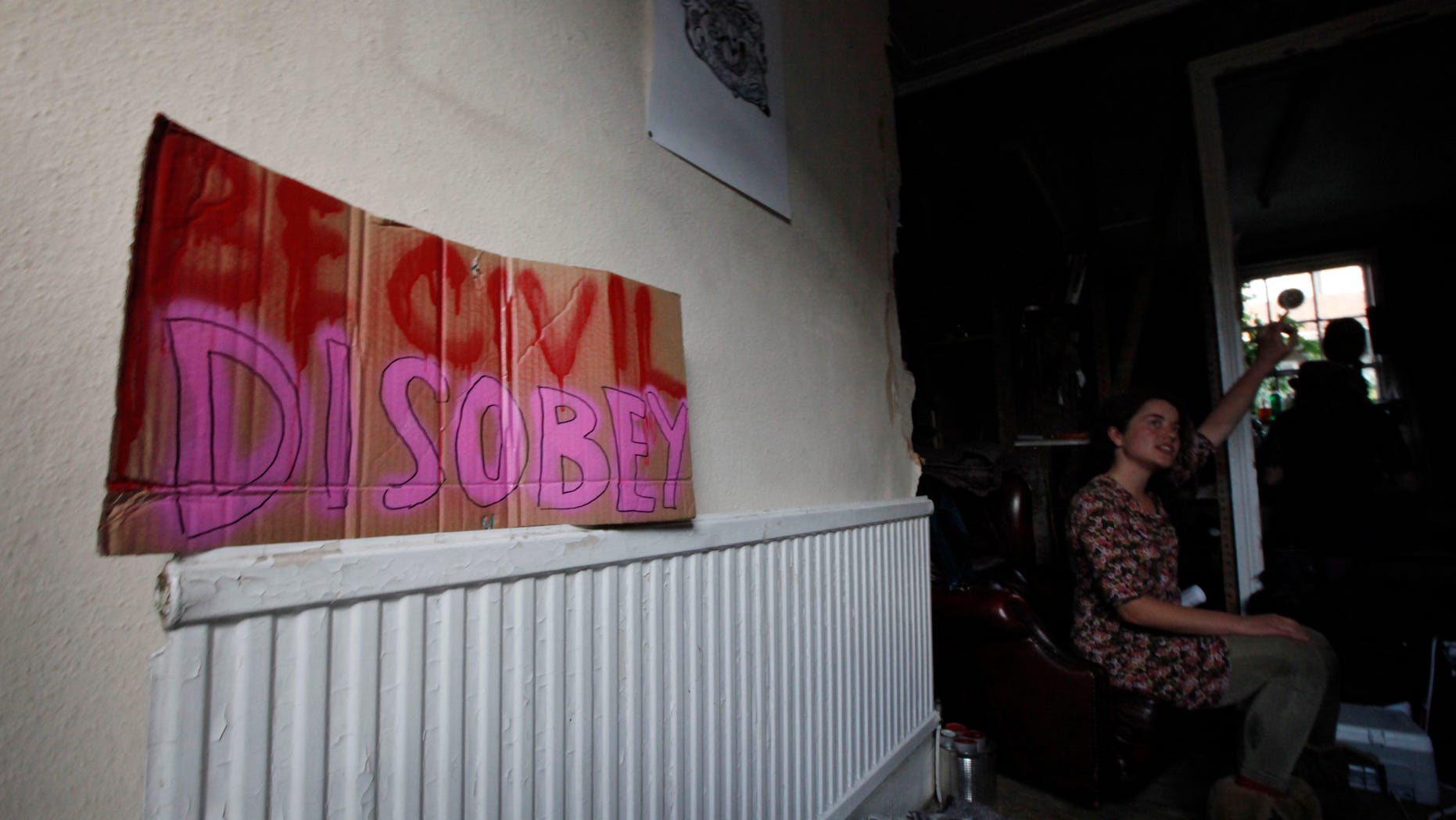 Rueben Taylor, 25, a squatter is seen at the house where she resides in London, Tuesday Oct. 11, 2011. Taylor lives with four others in the brick and stucco 19th-century row house on a street of $ 950,000 homes.