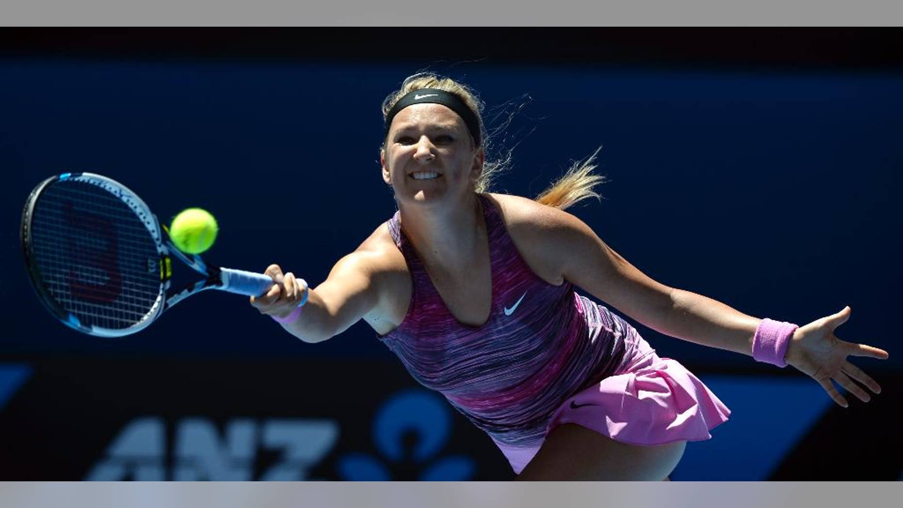 FILE - This is a Wednesday, Jan. 22, 2014 file photo of Victoria Azarenka from Belarus as she makes a forehand return to Agnieszka Radwanska of Poland during their quarterfinal at the Australian Open tennis championship in Melbourne, Australia. Former top-ranked Victoria Azarenka will return to competition next week at the Eastbourne grass-court tournament after a three-month layoff with a left foot injury. Tournament organizers say the Belarusian accepted a wild card entry Wednesday June 11, 2014 for the Wimbledon warmup event. (AP Photo/Andrew Brownbill, File)