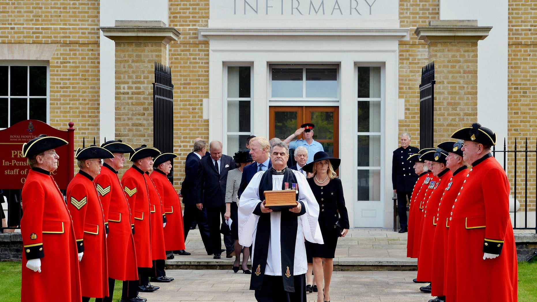 Sept. 28, 2013: Reverend Richard Whittington, foreground centre, carries an oak casket containing the ashes of former British Prime Minister Margaret Thatcher, followed by her daughter Carol, son Mark, centre left and his wife Sarah, centre left, after leaving the chapel, at the Royal Hospital Chelsea.