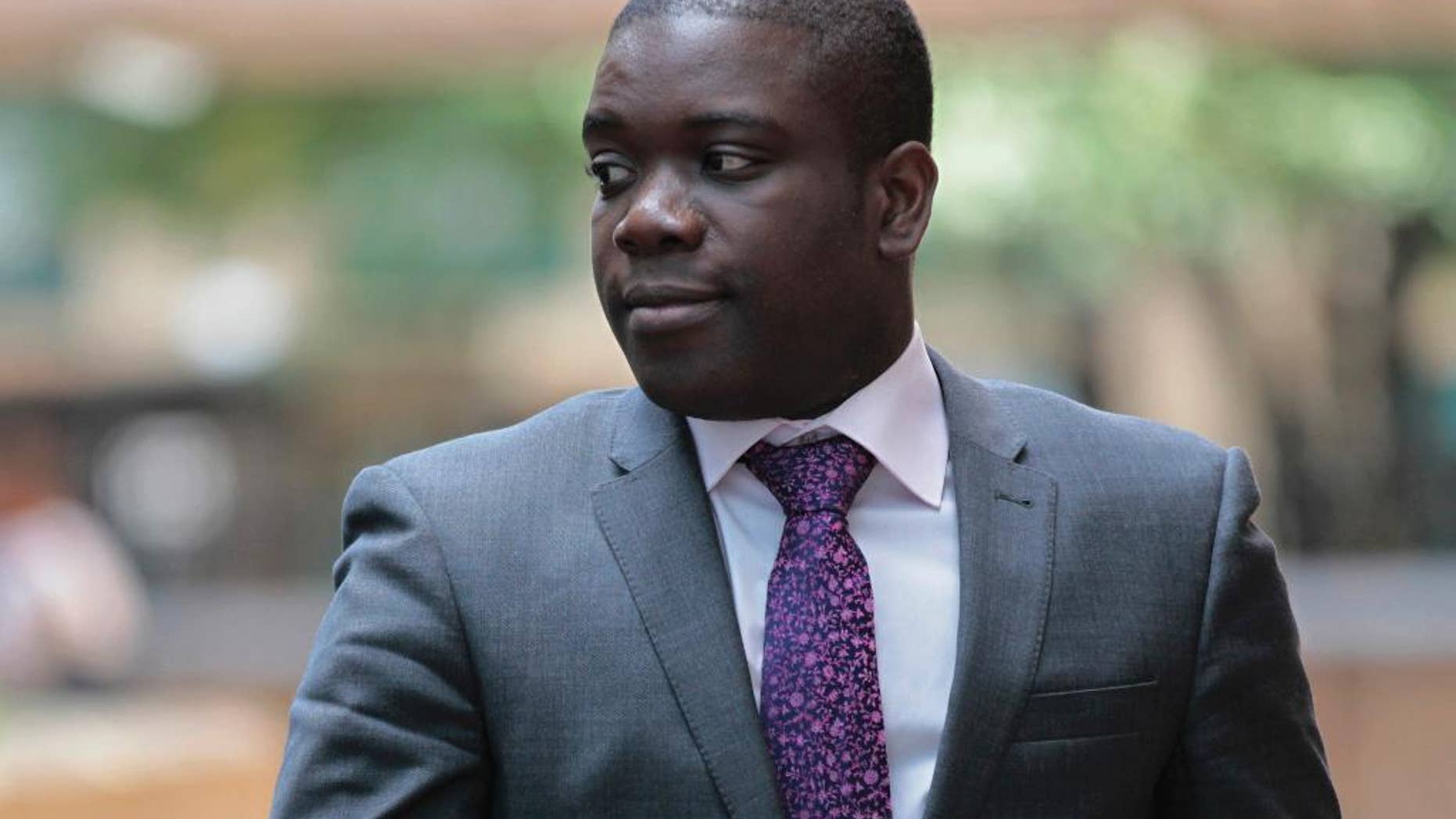 FILE This Tuesday, Sept. 18, 2012 file photo shows former trader Kweku Adoboli leaving Southwark Crown Court in London for a lunch break from his trial at the court. A rogue trader who lost $2.2 billion in bad deals at Swiss bank UBS was convicted of fraud on Tuesday, Nov. 20, 2012. It emerged Wednesday June 24, 2015 that Adoboli was released from prison last week after serving half of his seven-year sentence. (AP Photo/Sang Tan)