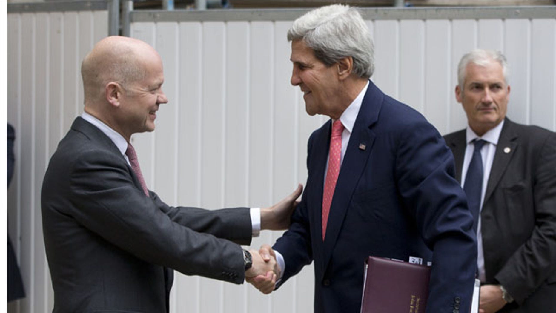 September 9, 2013: British Foreign Secretary William Hague, left, greets US Secretary of State John Kerry outside the Foreign Office in London. (AP Photo)