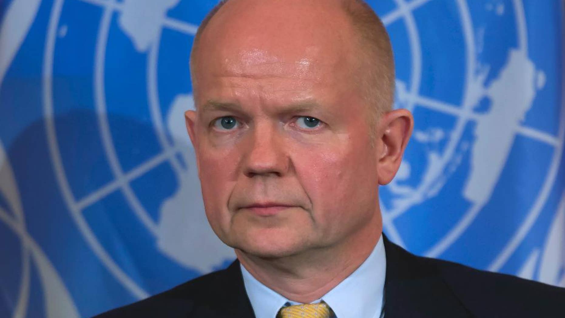 FILE - This is a Tuesday, Feb. 25, 2014 file photo of British Foreign Secretary William Hague as he pauses during a discussion on ending sexual violence and conflict in war, with Secretary of State John Kerry, at the State Department in Washington. Hague said Sunday March 2, 2014 that he is traveling to Kiev because he wants to meet personally with Ukraine's new leaders to discuss ways to defuse the crisis. (AP Photo/ Evan Vucci, File)