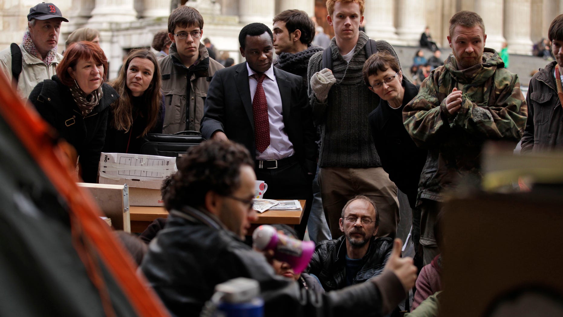 Oct. 21, 2011: People listen to an economics talk held at the so-called "Star Books Occupation Library" setup by Occupy London Stock Exchange protesters directly outside a branch of the Starbucks coffee chain as they continue their demonstration outside St Paul's Cathedral, near the London Stock Exchange in London.