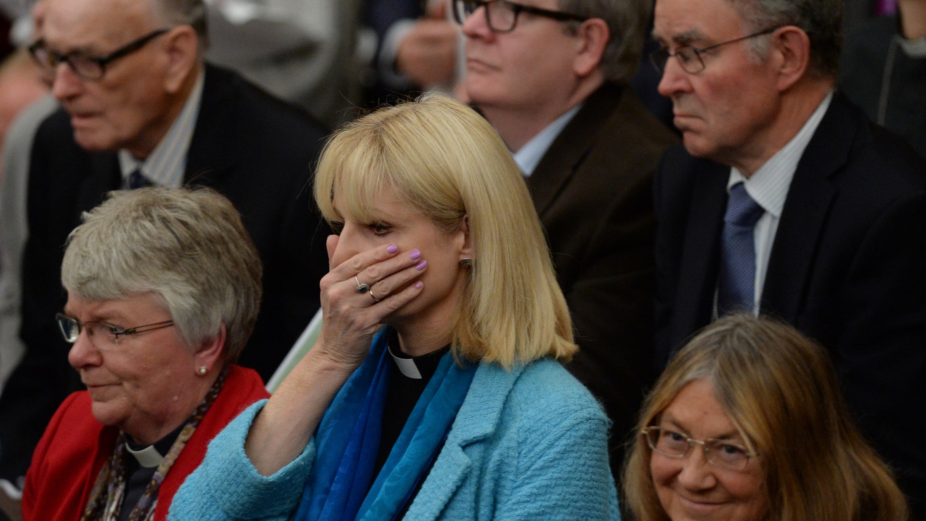 Nov. 17, 2014 - Female clergy react immediately after the General Synod voted in favor of women Bishops at the Anglican General Synod in Church House, London.