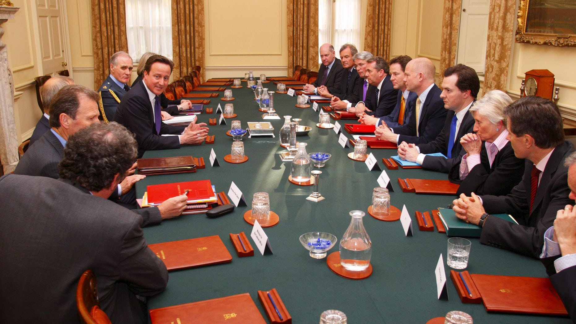 Britain's Prime Minister David Cameron, top, first left, chairs the first meeting of the National Security Council in the Cabinet Room at No.10 Downing Street. in central London, Wednesday, May 12, 2010. Others in attendance included Chief of the Defence Staff Sir Jock Stirrup, top left, Deputy Prime Minister Nick Clegg, fifth right, Foreign Secretary William Hague, sixth right, Chancellor George Osborne, seventh right and Defence Secretary Dr Liam Fox, fourth right. (AP Photo/Chris Ison, Pool)