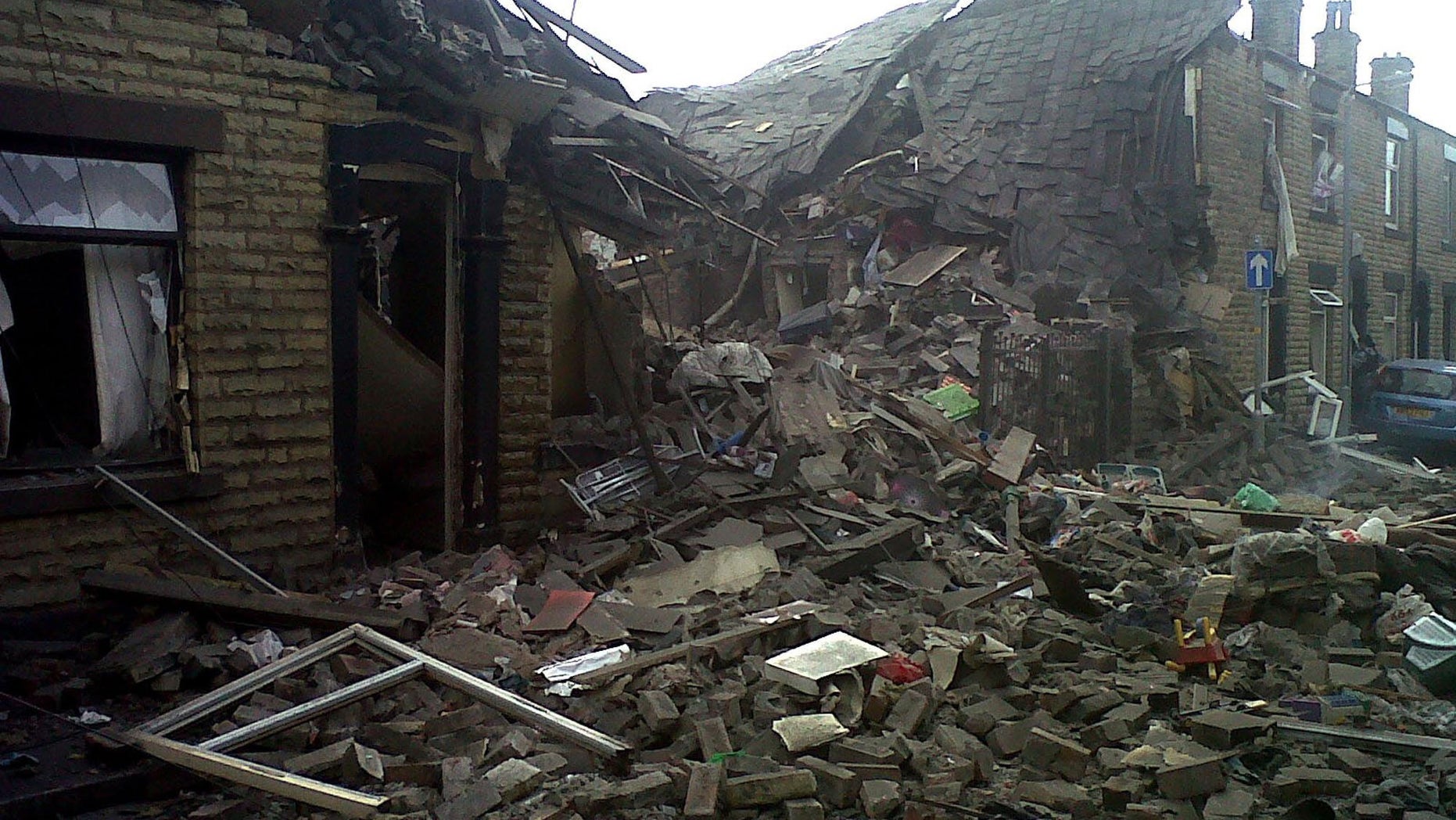 June 26, 2012: Damaged houses are seen at the scene of a suspected gas explosion in the Shaw area of Oldham England.