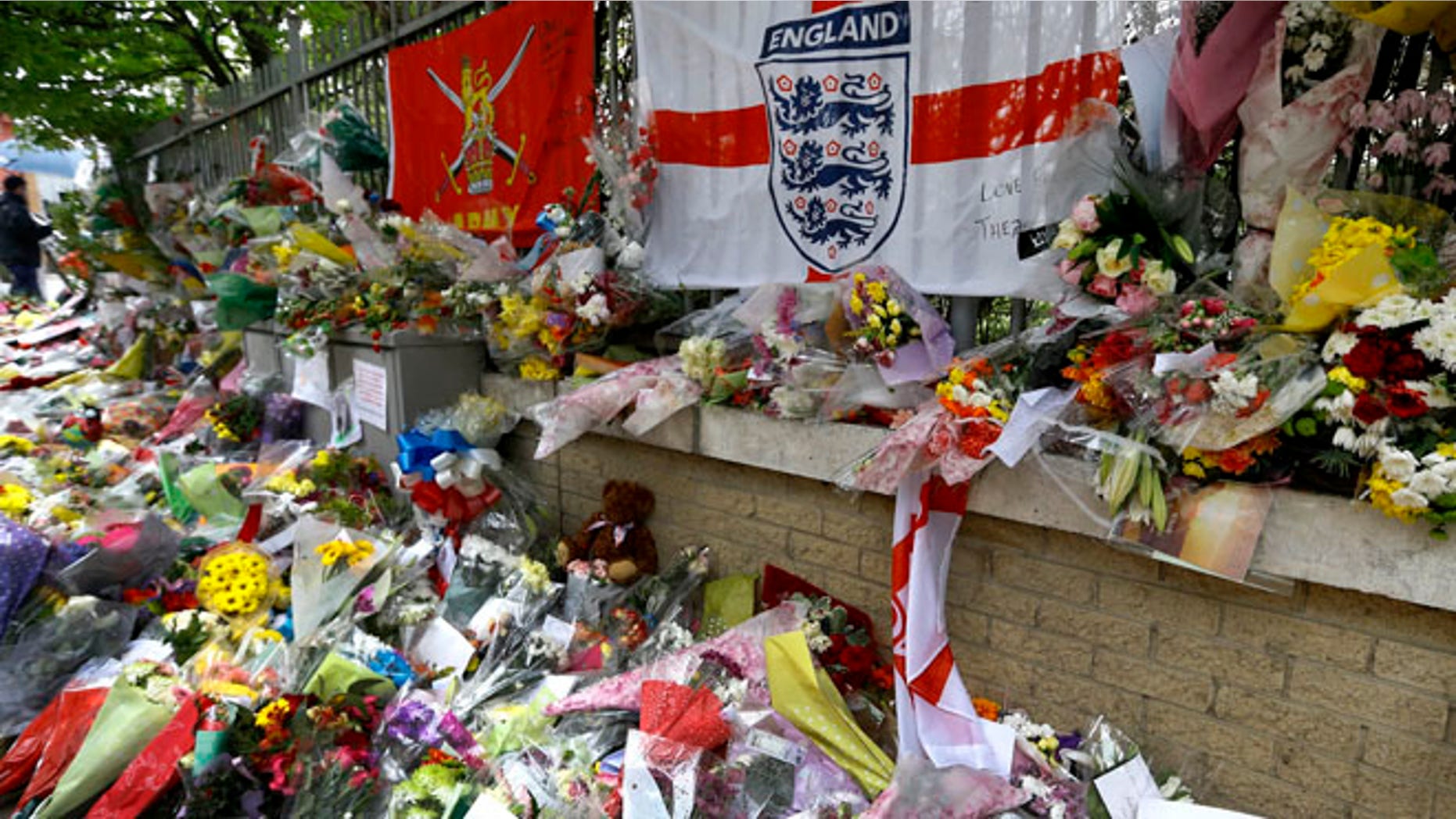 May 28, 2013: Some of the thousands of floral and other tributes left at the scene near Woolwich Barracks in London, where 25-year-old soldier of the Royal Regiment of Fusiliers Lee Rigby was attacked and killed last week.