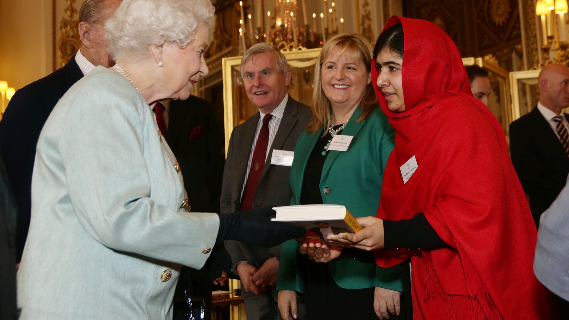 Oct. 18, 2013 - Malala Yousafzai gives a copy of her book to Britain's Queen Elizabeth II during a reception for youth, education and the Commonwealth at Buckingham Palace, London.