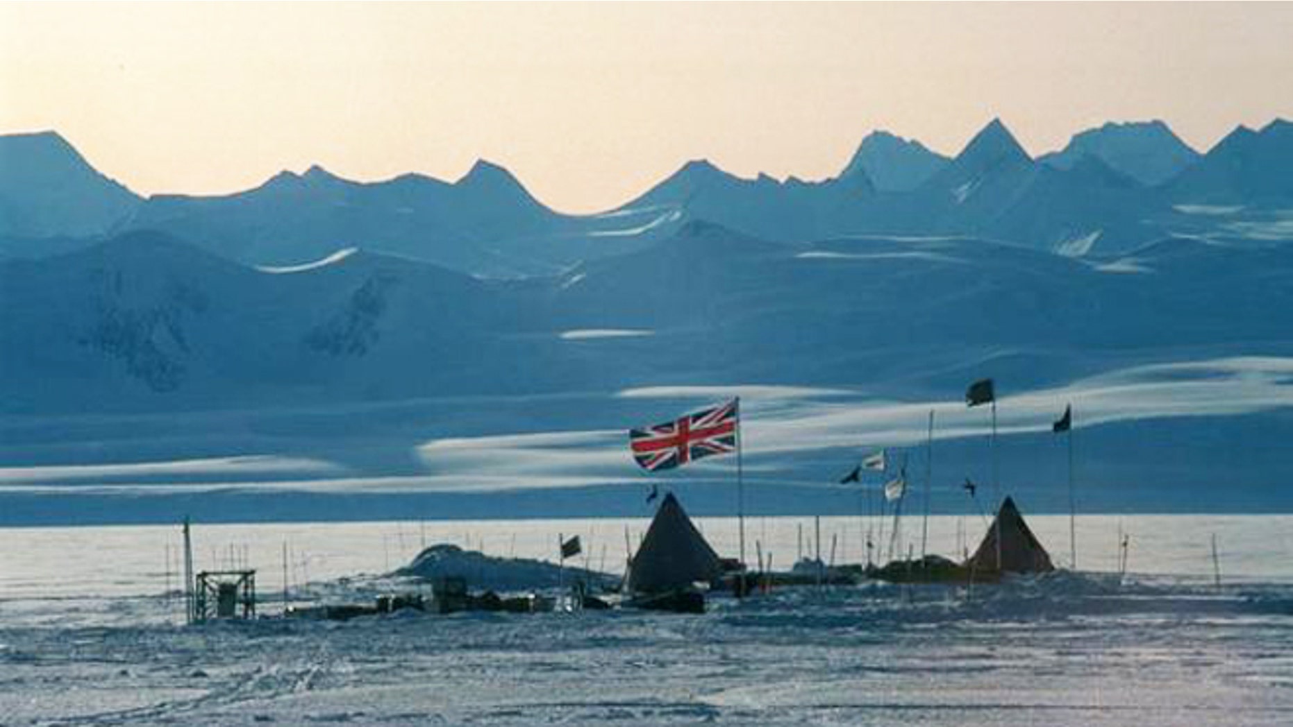 The Union Jack flies over a field camp at Lake Ellsworth. In the background are the Ellsworth Mountains, the highest range in Antarctica.