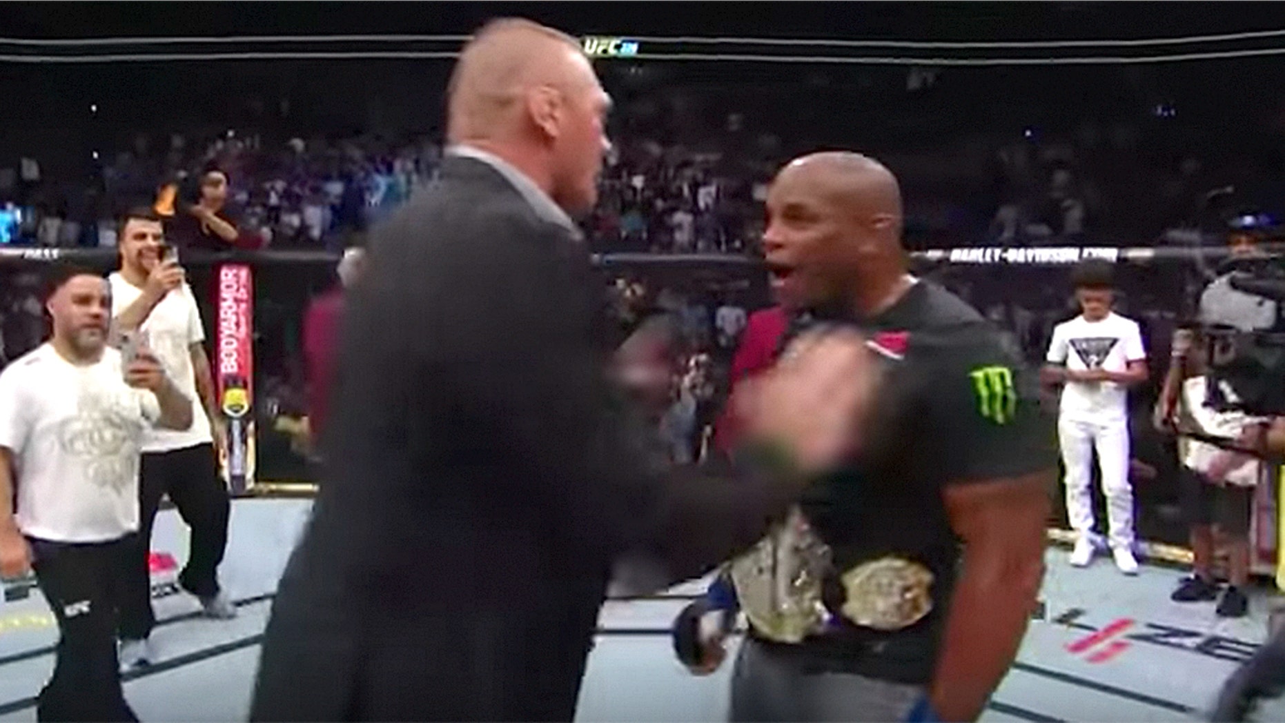 Brock Lesnar confronts Daniel Cormier in the octagon.