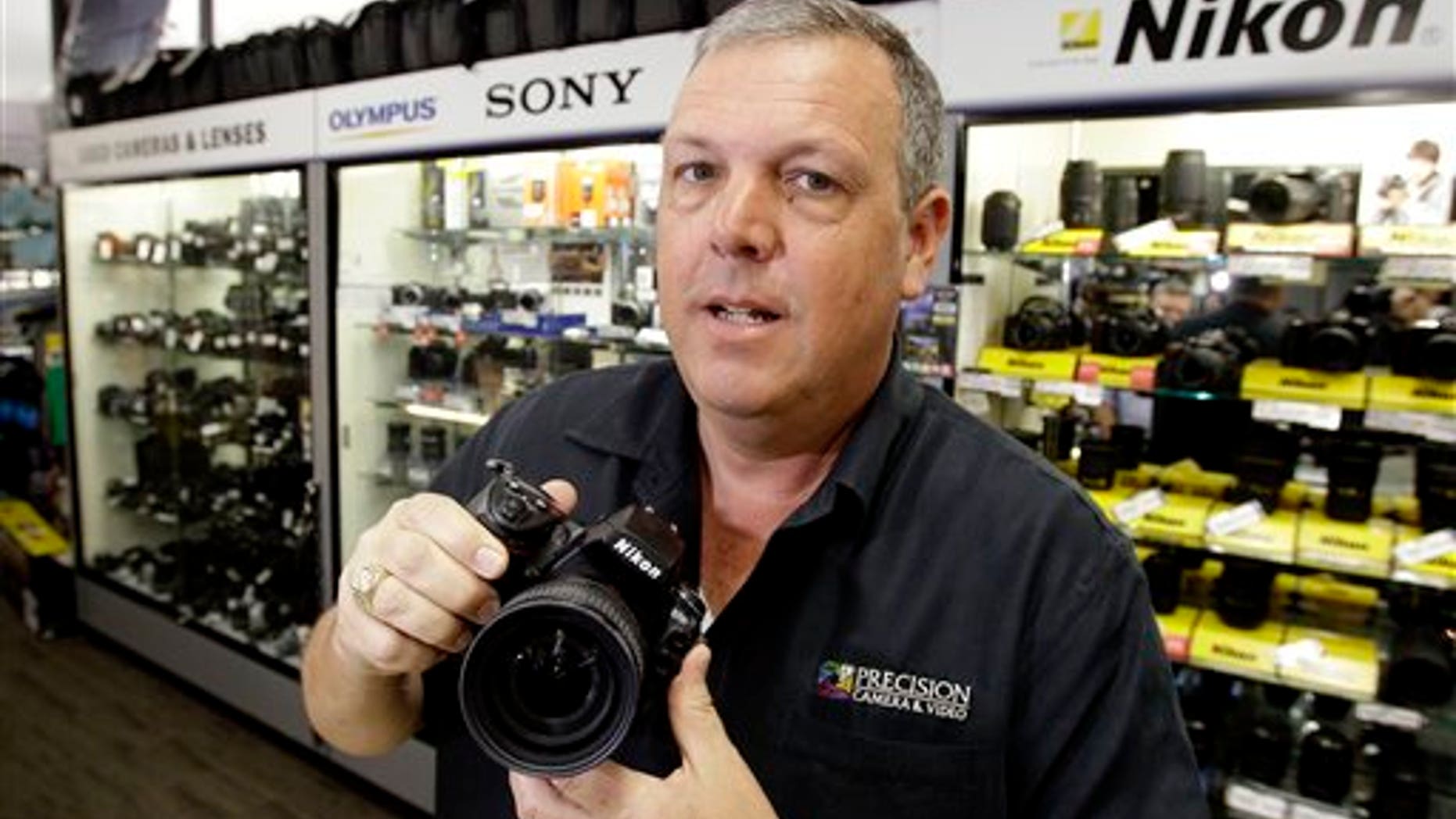 In this April 21, 2011 photo, Gregg Burger, general manager of Precision Camera, an independent retailer, poses for a photo at his store, in Austin, Texas. Burger has lobbied for legislation that would require out-of-state Internet retailers to collect Texas sales tax, creating what he calls a level playing field for local retailers.