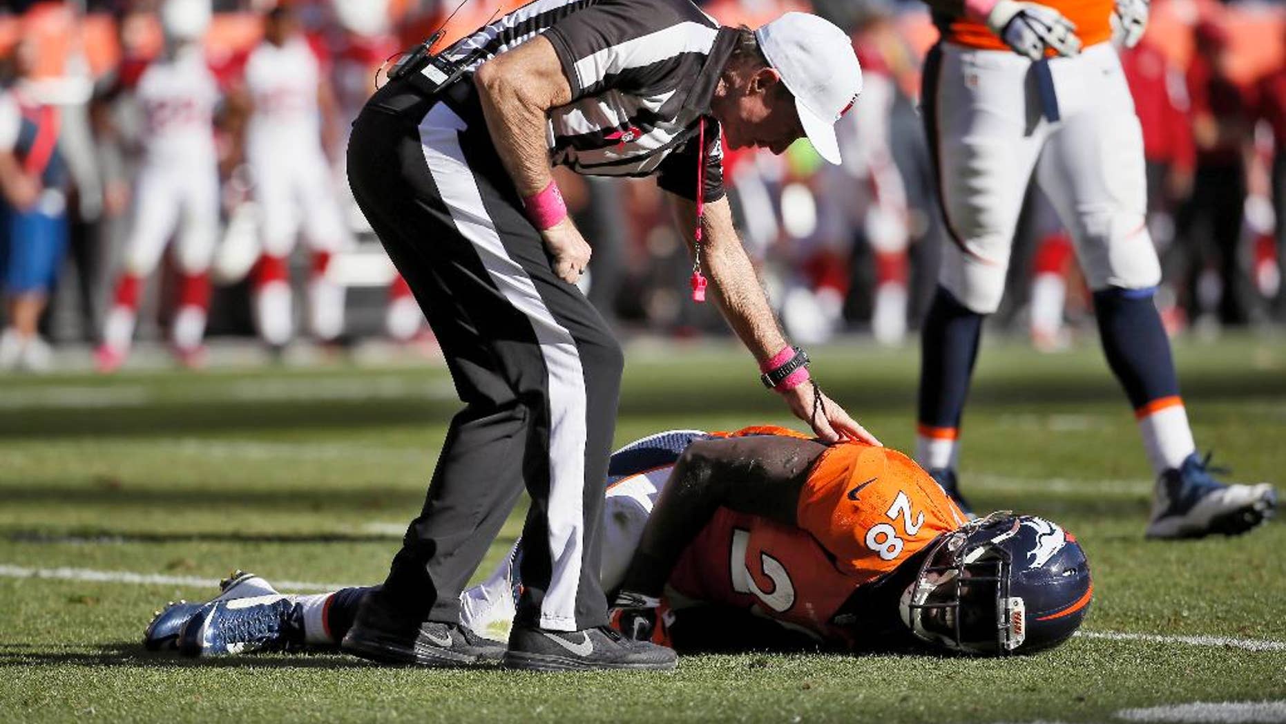 FILE - In this Oct. 5, 2014, file photo, a referee checks on injured Denver Broncos running back Montee Ball (28) during the second half of an NFL football game against the Arizona Cardinals in Denver. Ball was Mr. Durability at the University of Wisconsin, missing just one game while scoring an NCAA record 83 touchdowns. He hasn't had the same endurance in the NFL. (AP Photo/Jack Dempsey, File)