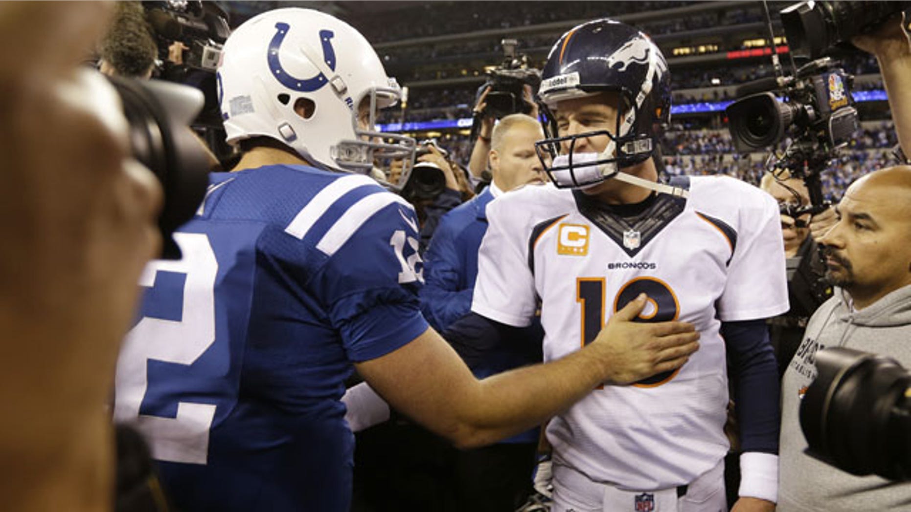 October 20, 2013: Denver Broncos quarterback Peyton Manning, right, greets Indianapolis Colts quarterback Andrew Luck (12) after an NFL football game in Indianapolis. The Colts won 39-33. (AP Photo/Michael Conroy)