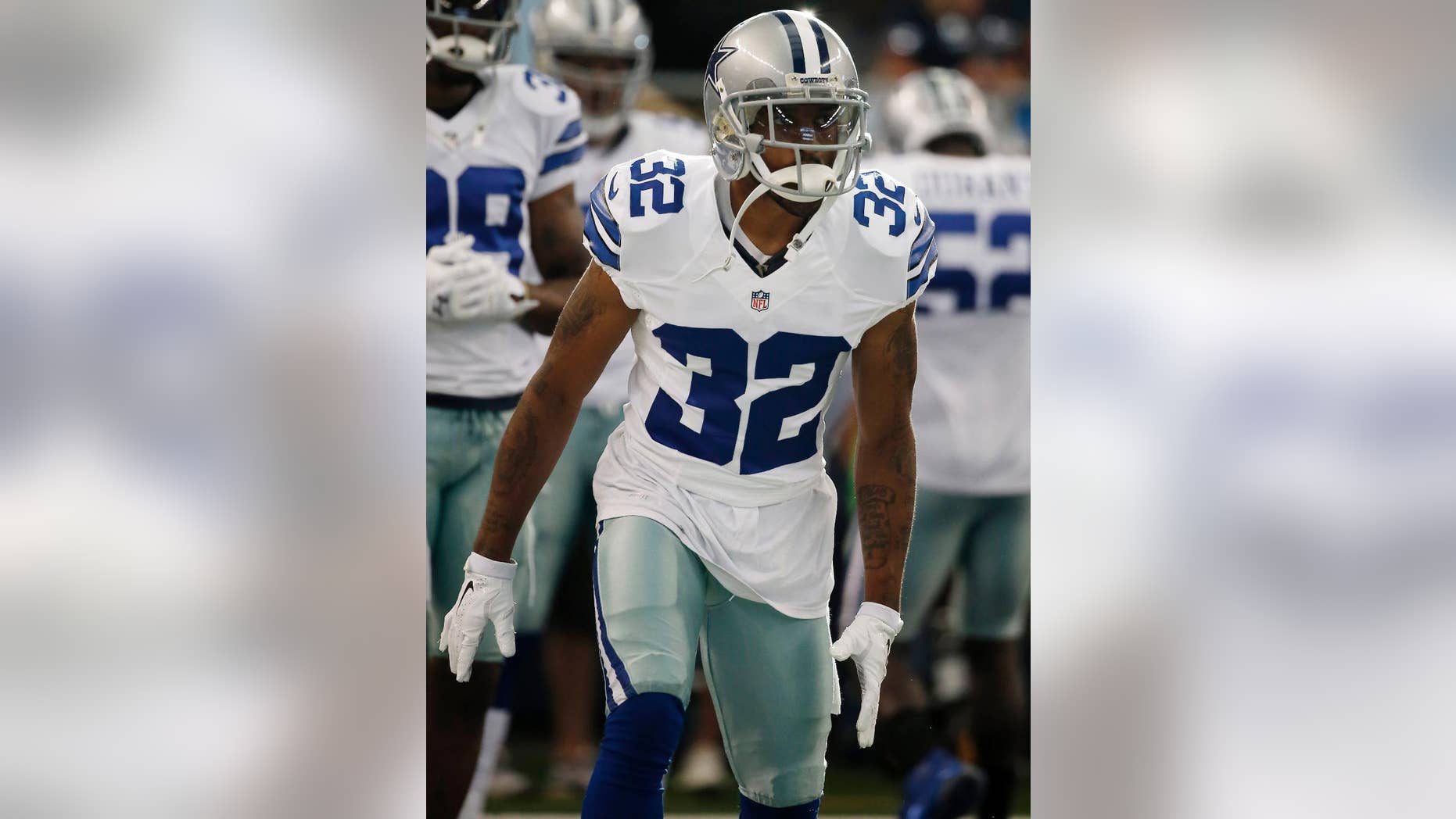 In this Aug. 28, 2014 photo, Dallas Cowboys cornerback Orlando Scandrick warms up before a NFL preseason football game against the Denver Broncos in Arlington, Texas. Scandrick will be back on the practice field two weeks early after his four-game suspension was reduced with the new agreement between the players and the league on a performance-enhancing drugs policy.(AP Photo/Brandon Wade)