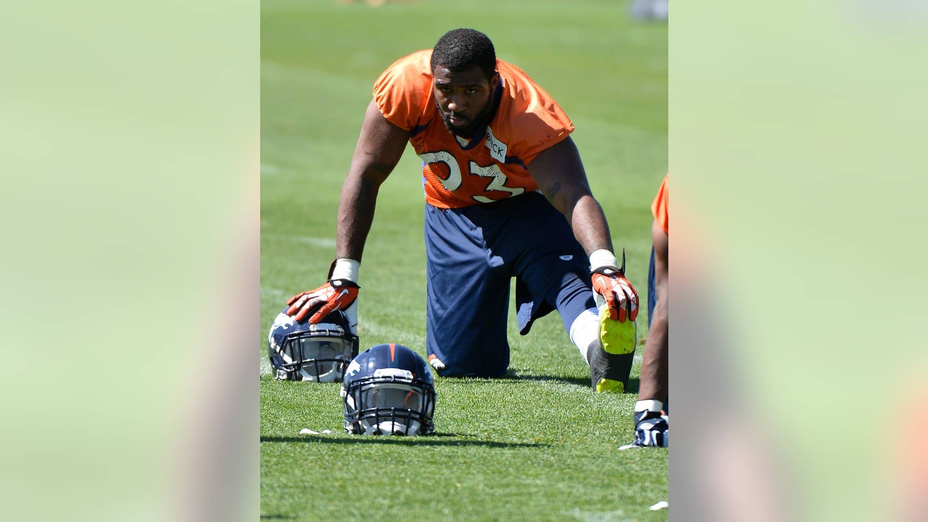 FILE - In this June 2, 2014, file phot0, Denver Broncos' Quanterus Smith stretches during an NFL football organized team activity in Englewood, Colo. Smith, a second-year pro from Western Kentucky who spent his rookie season on injured reserve, turned heads during the Broncos' offseason workouts, flashing the speed and skills like he showed on that three-sack day at Alabama that first put him on the NFL radar back in 2012. (AP Photo/Jack Dempsey, File)