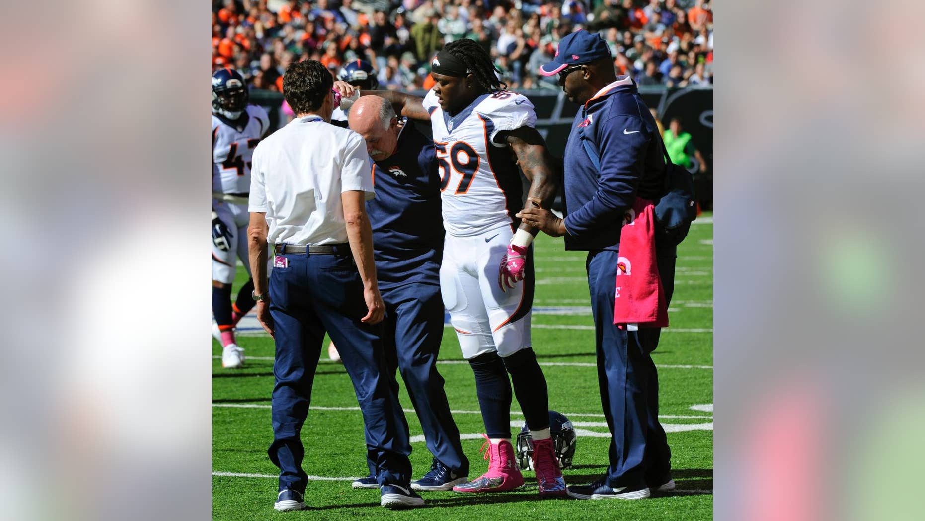 Denver Broncos outside linebacker Danny Trevathan (59) is helped off the field in the first quarter of an NFL football game against New York Jets, Sunday, Oct. 12, 2014, in East Rutherford, N.J. The Denver Broncos await test results on Trevathan's left leg, the same one he fractured in training camp. (AP Photo/Bill Kostroun)