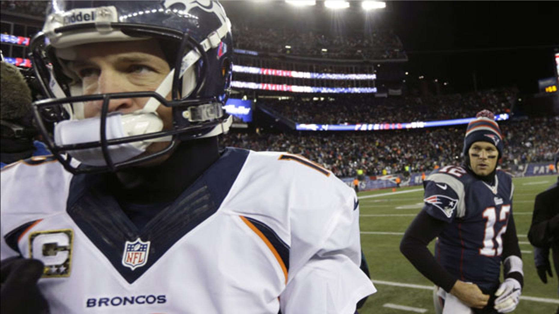 November 25, 2013: Denver Broncos quarterback Peyton Manning, left, walks from New England Patriots quarterback Tom Brady after an NFL football game in Foxborough, Mass. The Patriots won 34-31 in overtime. (AP Photo/Steven Senne)