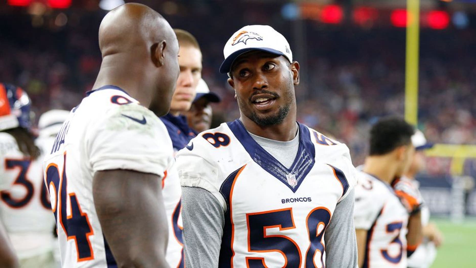 Aug 22, 2015; Houston, TX, USA; Denver Broncos linebacker Von Miller (58) talks with defensive end DeMarcus Ware (94) on the sidelines during the game against the Houston Texans at NRG Stadium. Mandatory Credit: Matthew Emmons-USA TODAY Sports