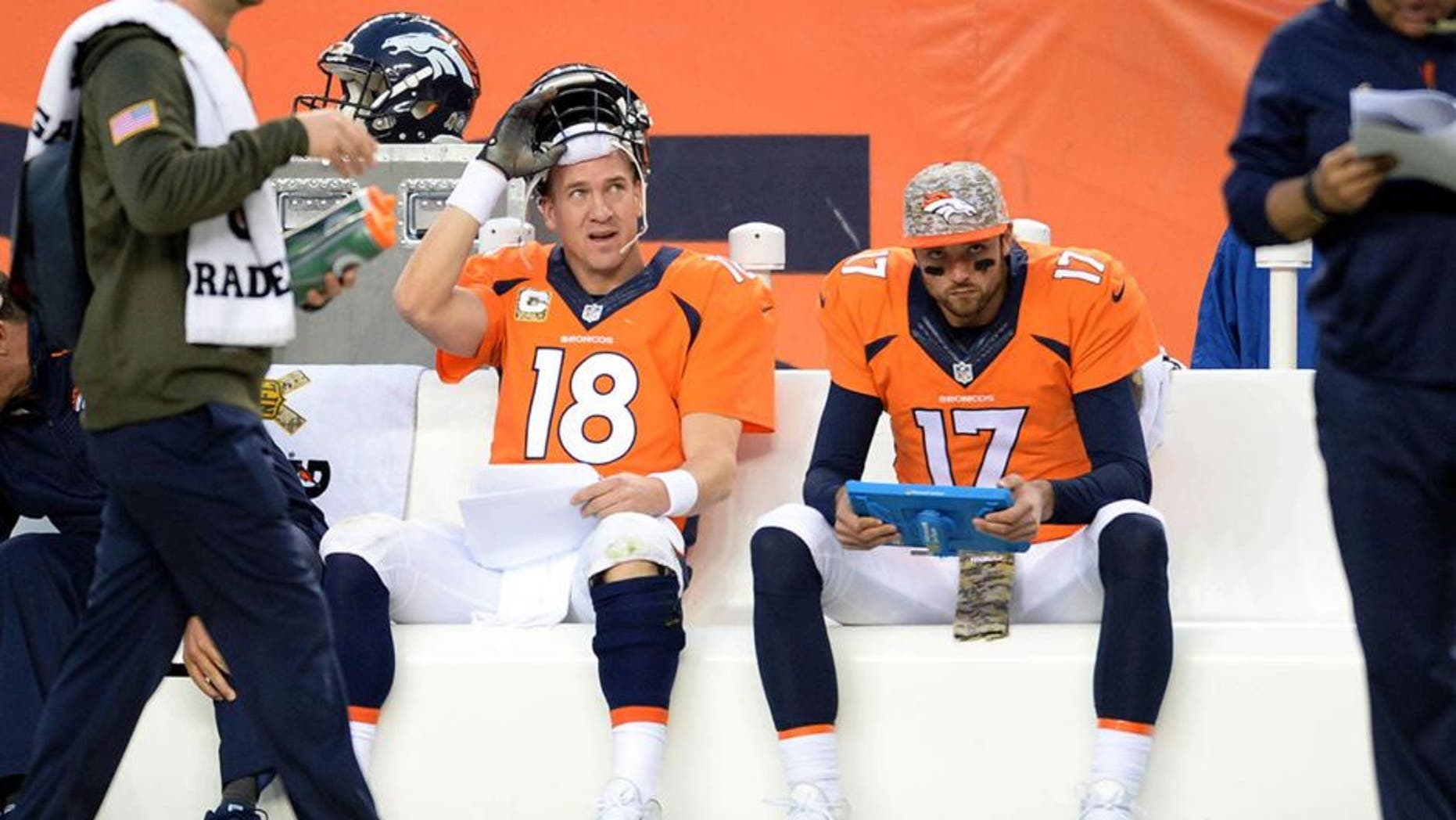 Nov 15, 2015; Denver, CO, USA; Denver Broncos quarterback Peyton Manning (18) sits on the bench along with quarterback Brock Osweiler (17) in the fourth quarter against the Kansas City Chiefs at Sports Authority Field at Mile High. Mandatory Credit: Ron Chenoy-USA TODAY Sports