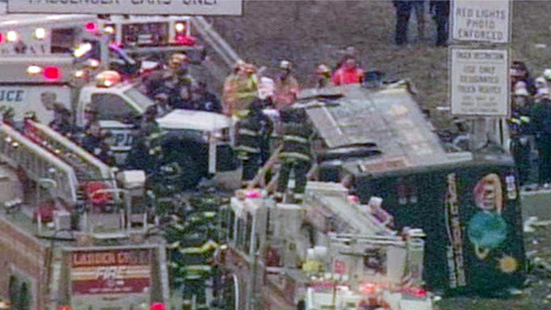 March 12: Fire and rescue officials surround a tour bus that overturned on the New England Thruway in the Bronx, killing at least 13 people.