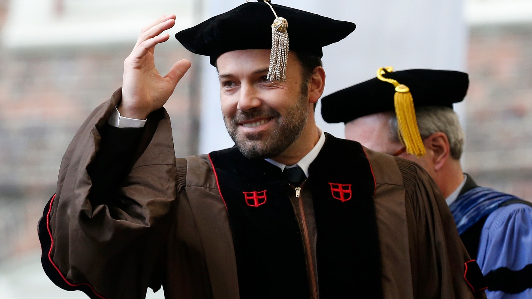 Ben Affleck gestures before receiving an honorary degree at Brown University's 245th commencement in Providence, R.I., Sunday, May 26, 2013. (AP Photo/Michael Dwyer)