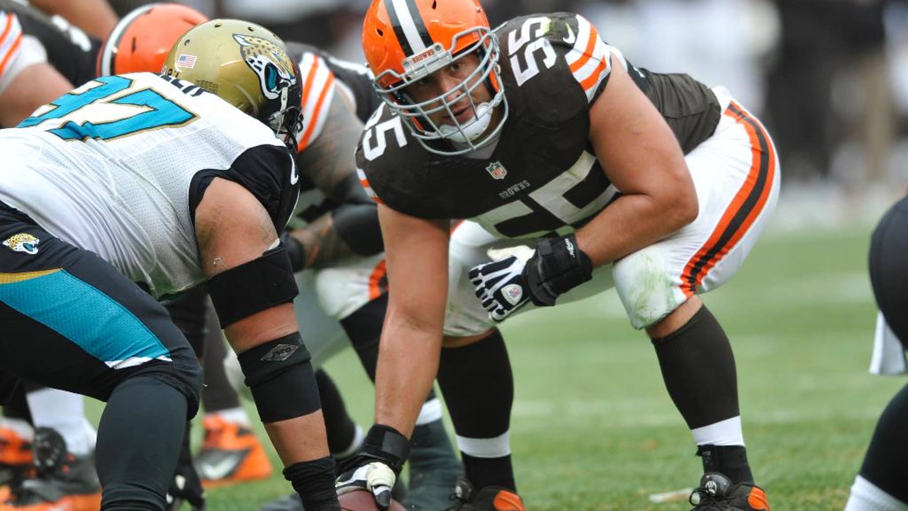 FILE - This Dec. 1, 2013 file photo shows Cleveland Browns center Alex Mack (55) in action during an NFL football game against the Jacksonville Jaguars, in Cleveland. Browns Pro Bowl center Alex Mack's football future could be decided in the next few days _ or hours. The Jacksonville Jaguars are expected to sign Mack to a contract offer sheet on Friday, April 11, 2014. Once the paperwork is filed, the Browns will have five days to match. Cleveland secured that right after placing a $10 million transition tag on Mack before free agency opened. (AP Photo/David Richard, File)