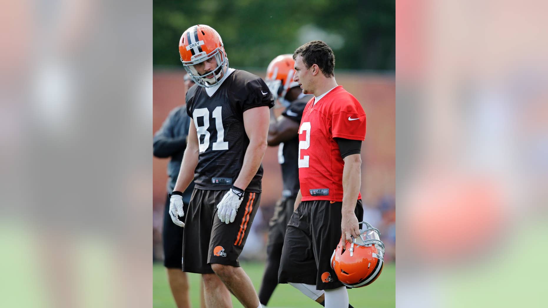Cleveland Browns quarterback Johnny Manziel (2) talks with tight end Jim Dray (81) during the first practice at the NFL football team's training camp in Berea, Ohio Saturday, July 26, 2014. (AP Photo)