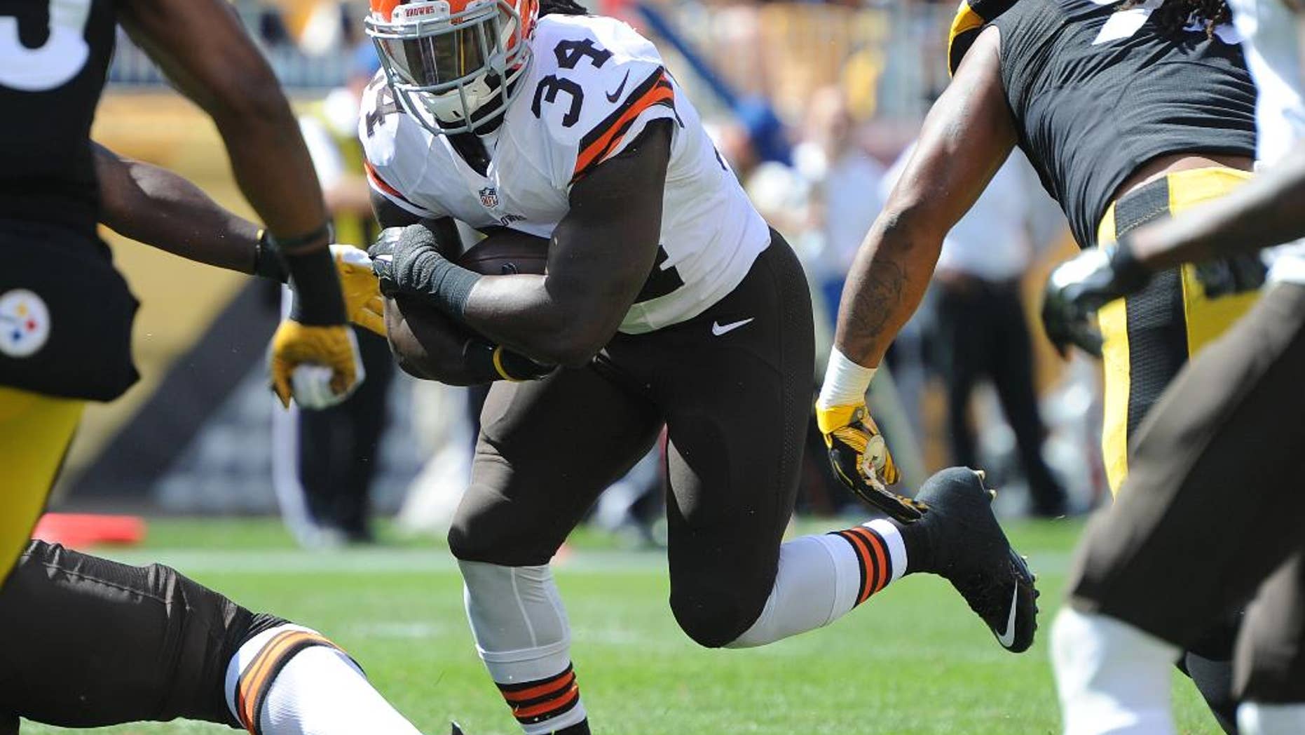 FILE -This Sunday, Sept. 7, 2014, file photo shows Cleveland Browns running back Isaiah Crowell (34) carrying the ball against the Pittsburgh Steelers during the third quarter of an NFL football game in Pittsburgh. With starting running back Ben Tate expected to miss Sunday's, Sept. 14, 2014, game with a knee injury, the Browns will again turn to rookies Terrance West and Crowell this week against New Orleans. West rushed for 100 yards, 91 in the second half, and Crowell had two touchdowns in their debuts last week against Pittsburgh. (AP Photo/Don Wright, File)