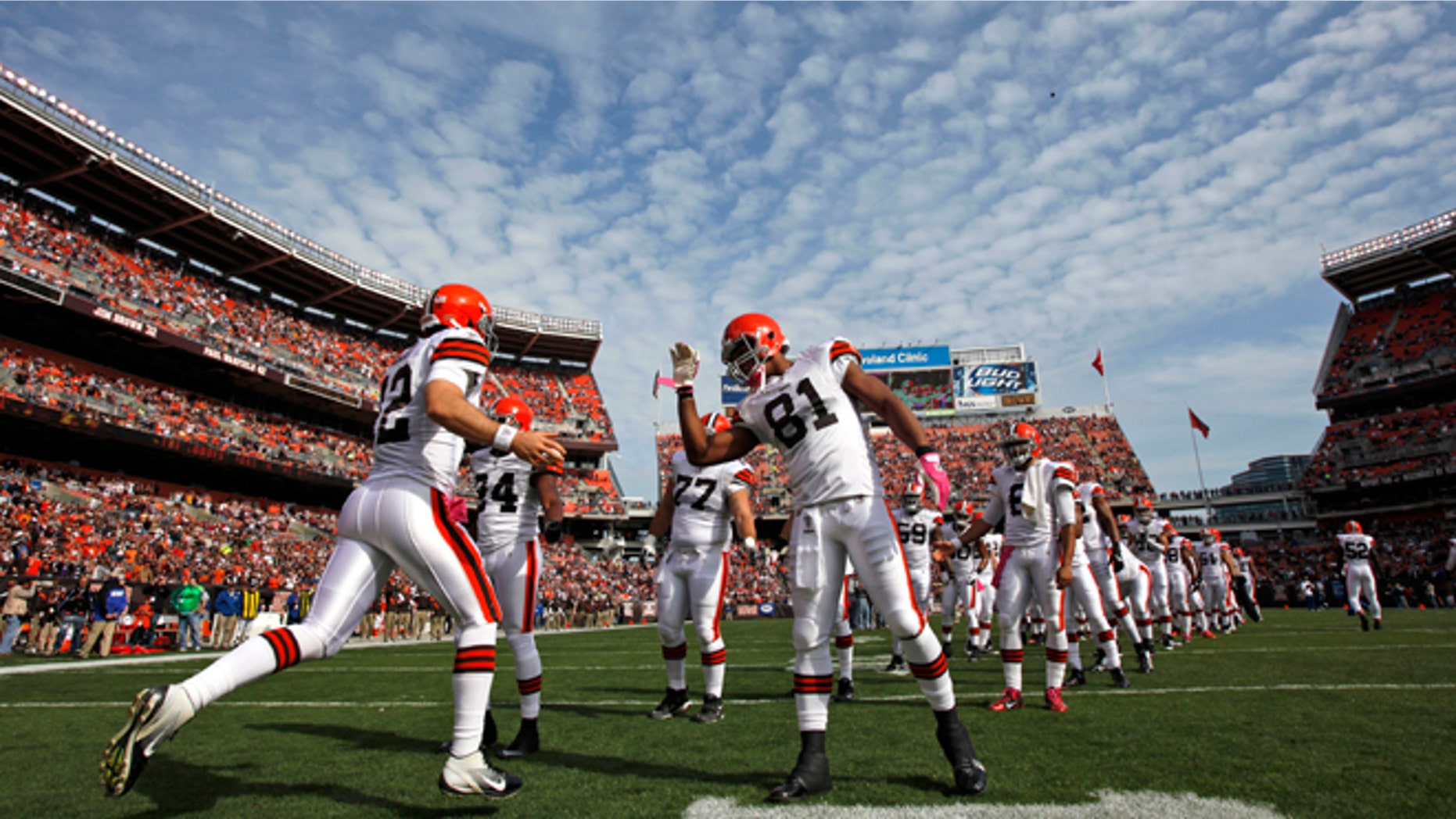 Oct. 23, 2011: In this file photo, Cleveland Browns' quarterback Colt McCoy (12) is greeted by his team during player introductions before taking on the Seattle Seahawks in an NFL football game in Cleveland.