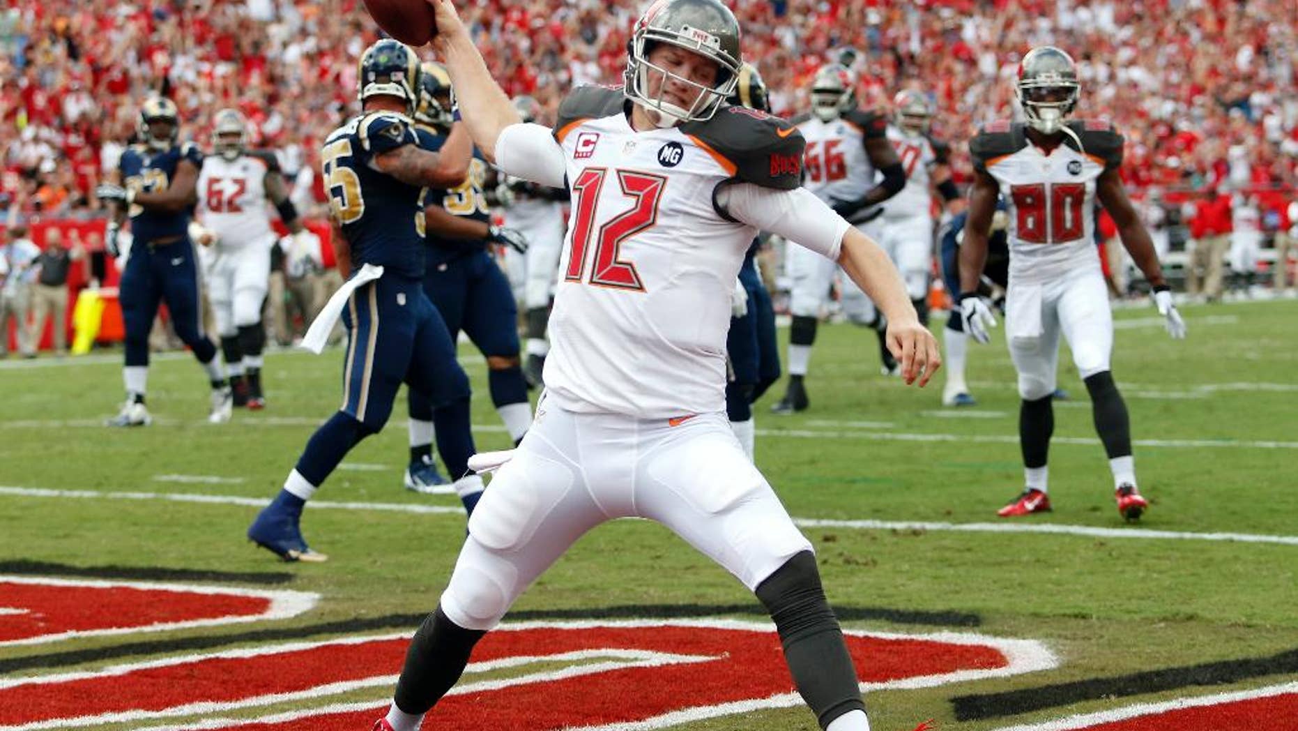 FILE - In this Sept. 14, 2014, file photo, Tampa Bay Buccaneers quarterback Josh McCown spikes the football after scoring on a 5-yard touchdown run against the St. Louis Rams during an NFL football game in Tampa, Fla. Hoping to spark one of the NFL's least productive offenses, the Buccaneers are turning back to McCown at quarterback.The 12th-year pro started the first three games of the season, but has missed the past five after injuring the thumb on his throwing hand. (AP Photo/Brian Blanco, File)
