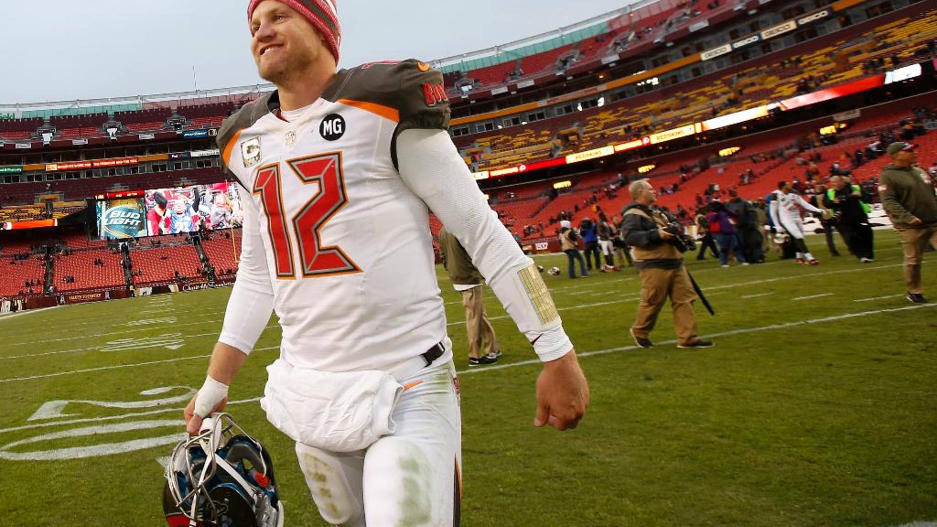 Tampa Bay Buccaneers quarterback Josh McCown (12) smiles as he walks off the field after a 27-7 victory over the Washington Redskins in an NFL football game in Landover, Md., Sunday, Nov. 16, 2014. (AP Photo/Alex Brandon)